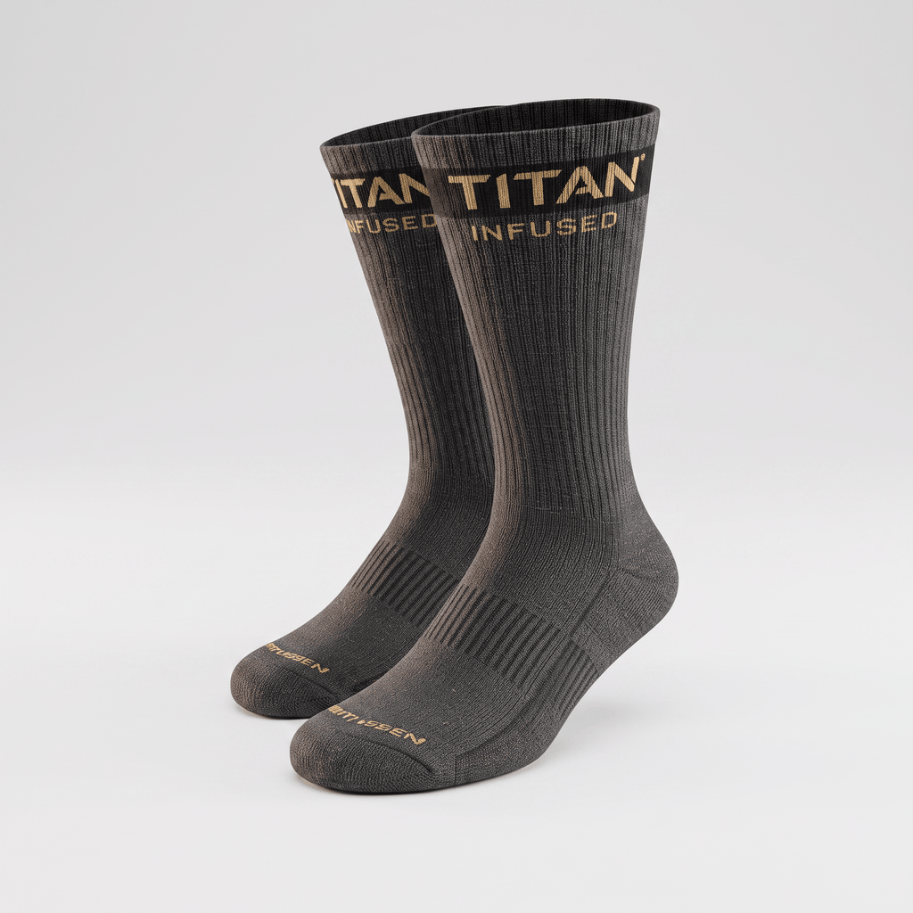 Charcoal grey crew socks with Titan Infused logo branding in gold text on a plain white background.
