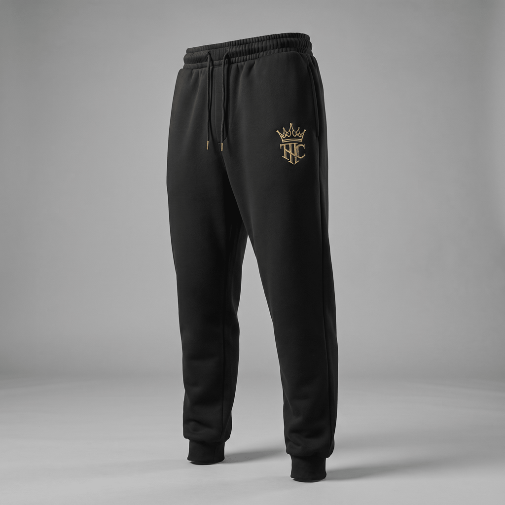 Black fleece sweatpants with a drawstring waist and gold crown logo on the left thigh.