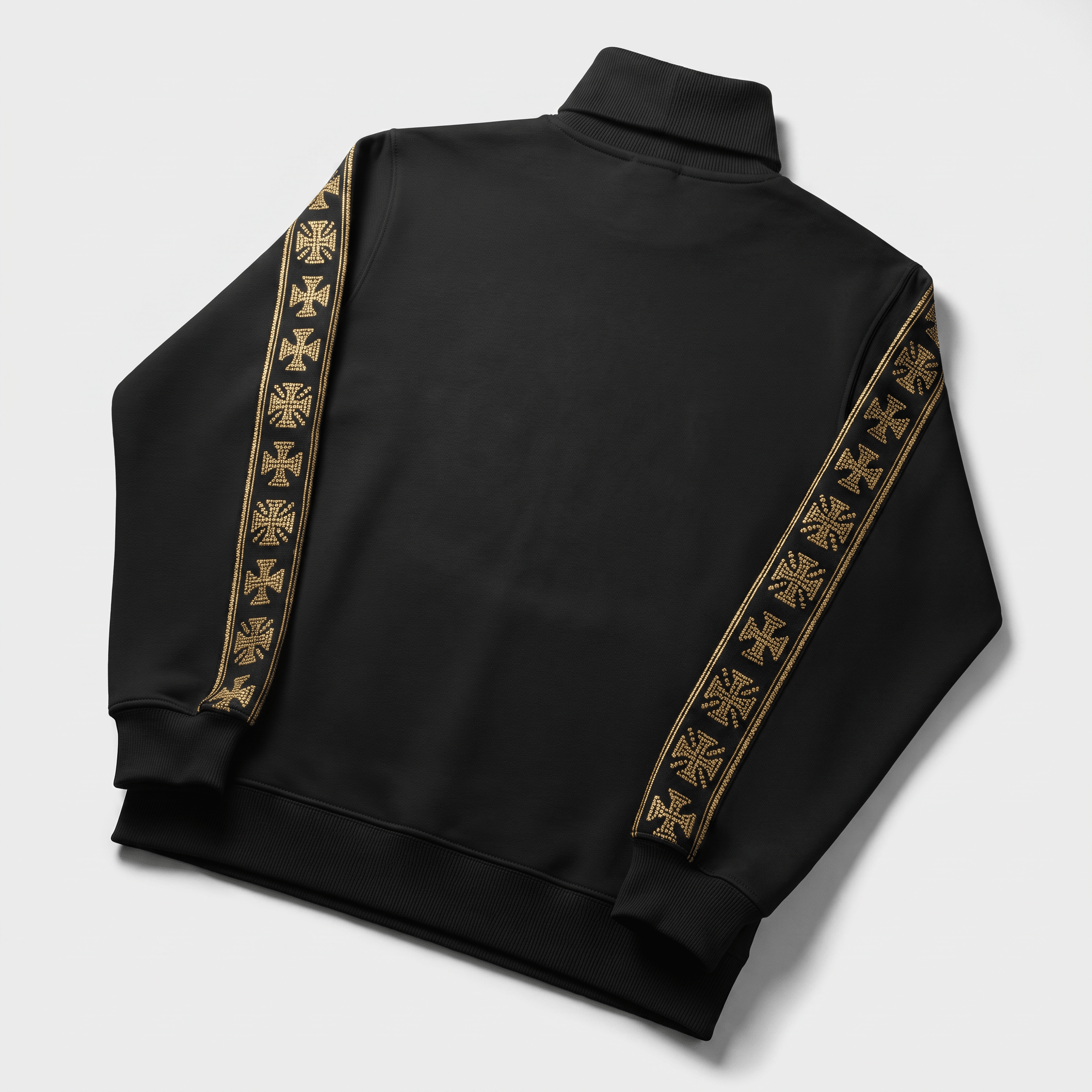 Back view of a black track jacket with gold rhinestone cross tape down the sleeves and a mock neck.