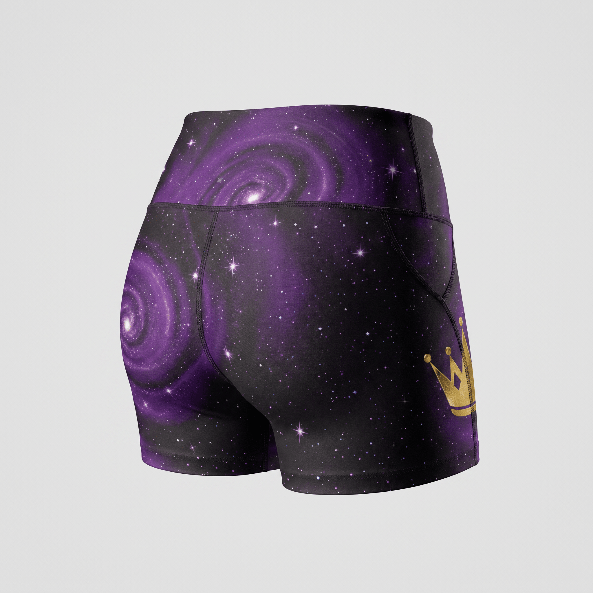 Back view of high-waisted purple galaxy print athletic shorts with a gold crown logo on the side pocket.