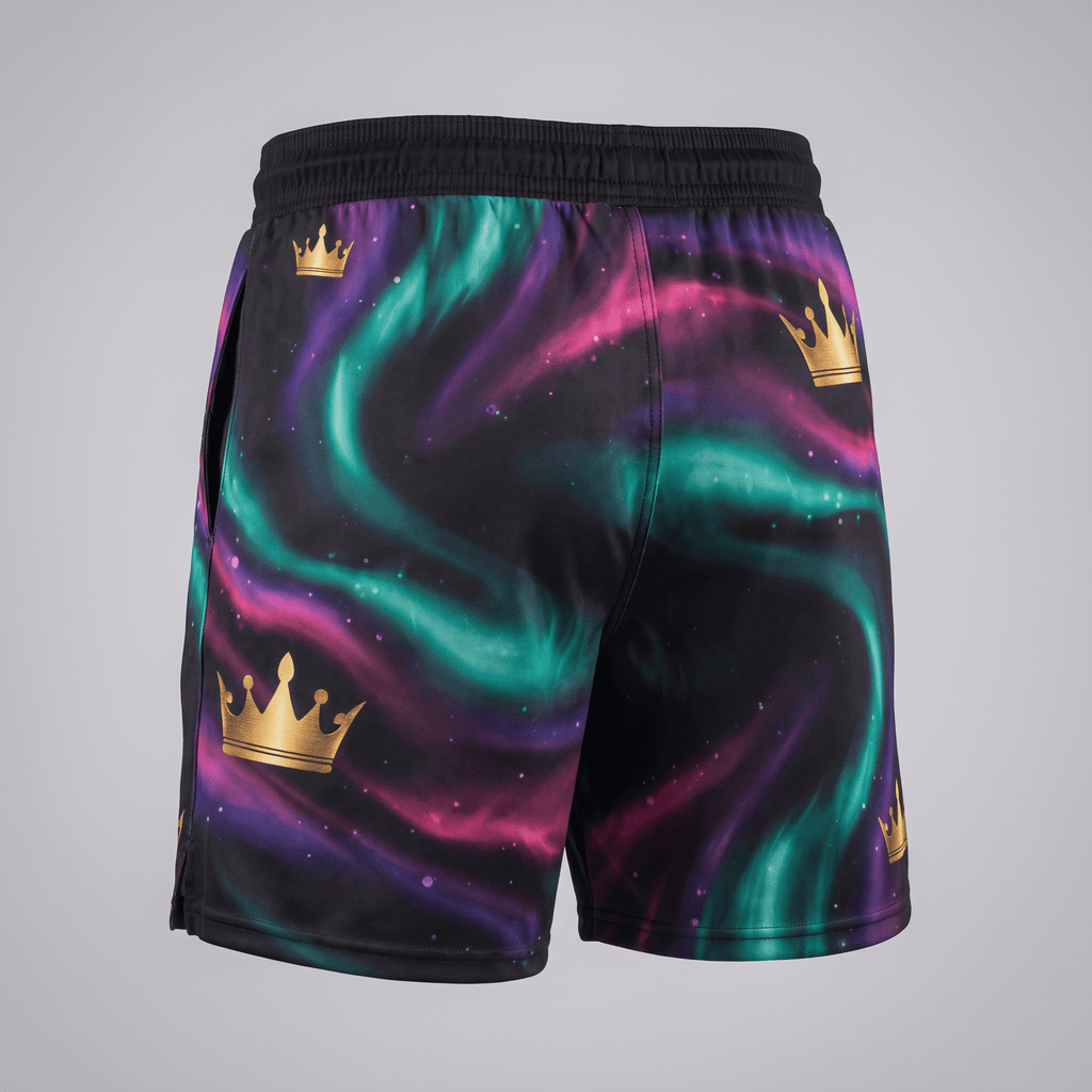 Back view of athletic shorts with black, purple, and green nebula print and gold crown graphics.