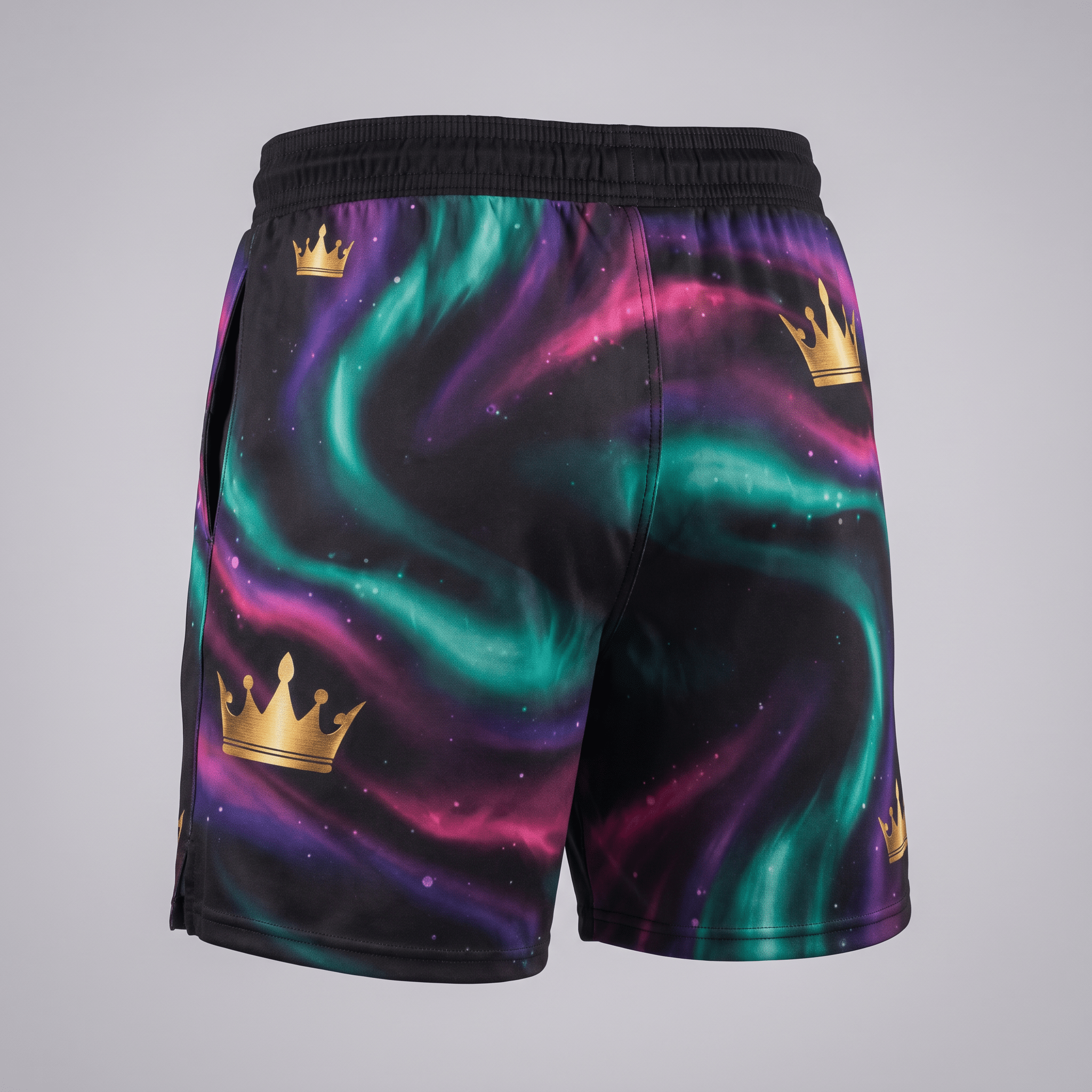 Back view of athletic shorts with black, purple, and green nebula print and gold crown graphics.