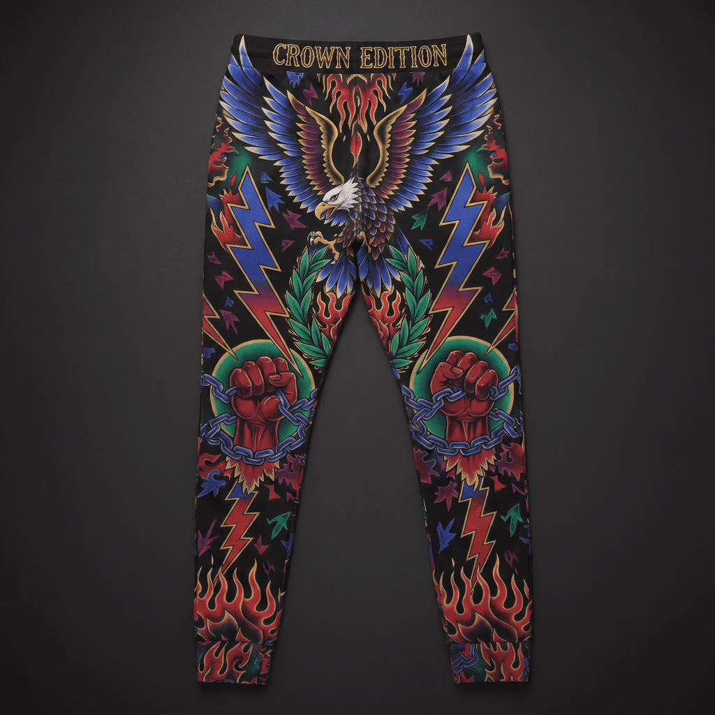 Black graphic sweatpants featuring a bold eagle, lightning bolts, and clenched fists tattoo print.