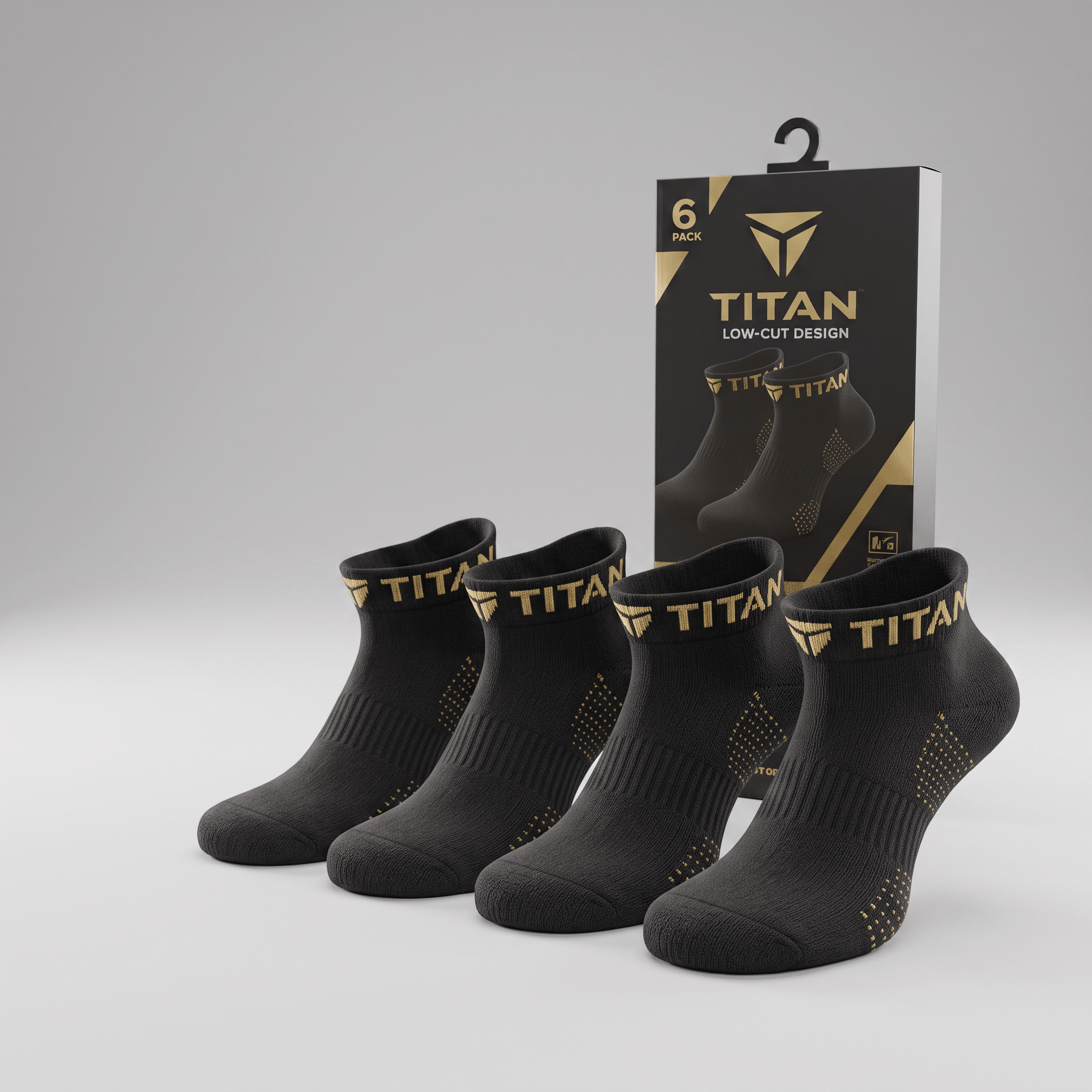 Four black Titan low-cut athletic socks with gold branding and grip dots, displayed with packaging.