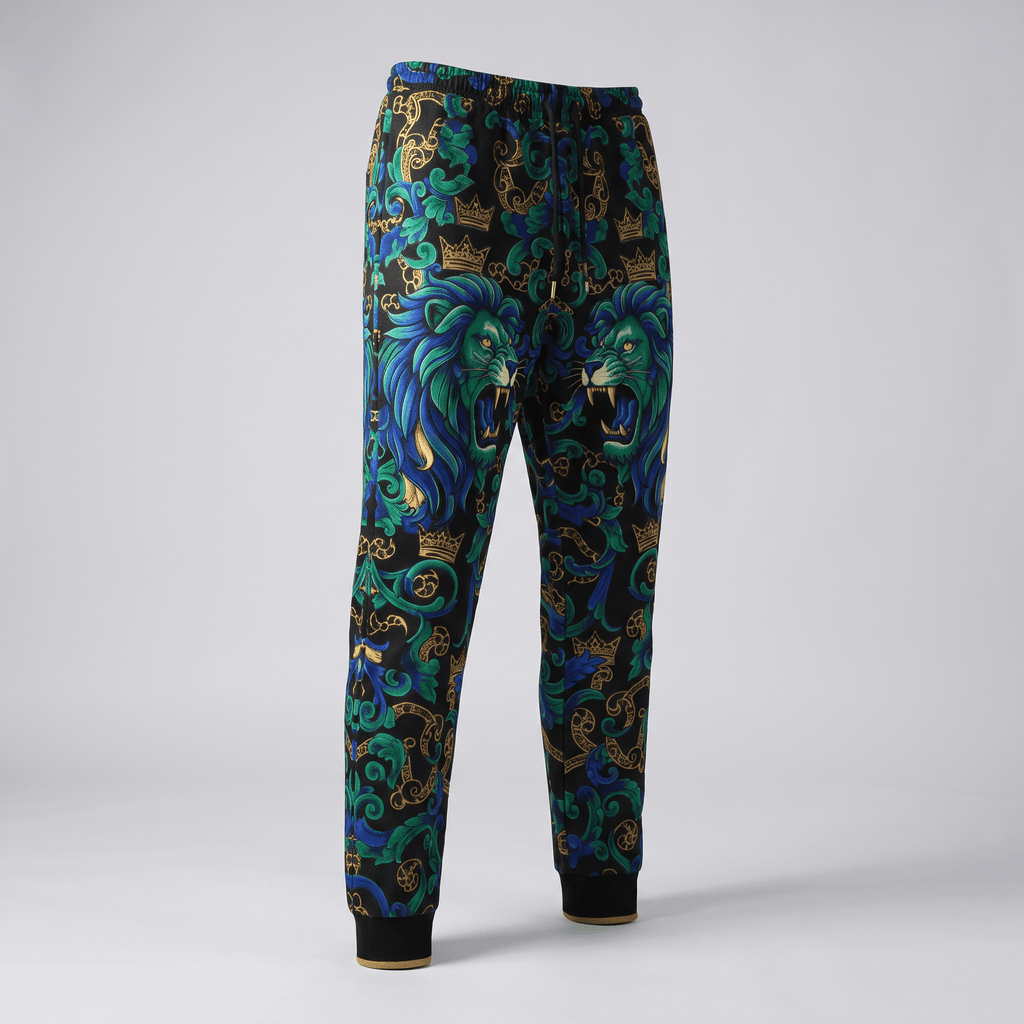 Black sweatpants featuring a blue and green lion print with gold baroque crowns and swirling scrollwork.