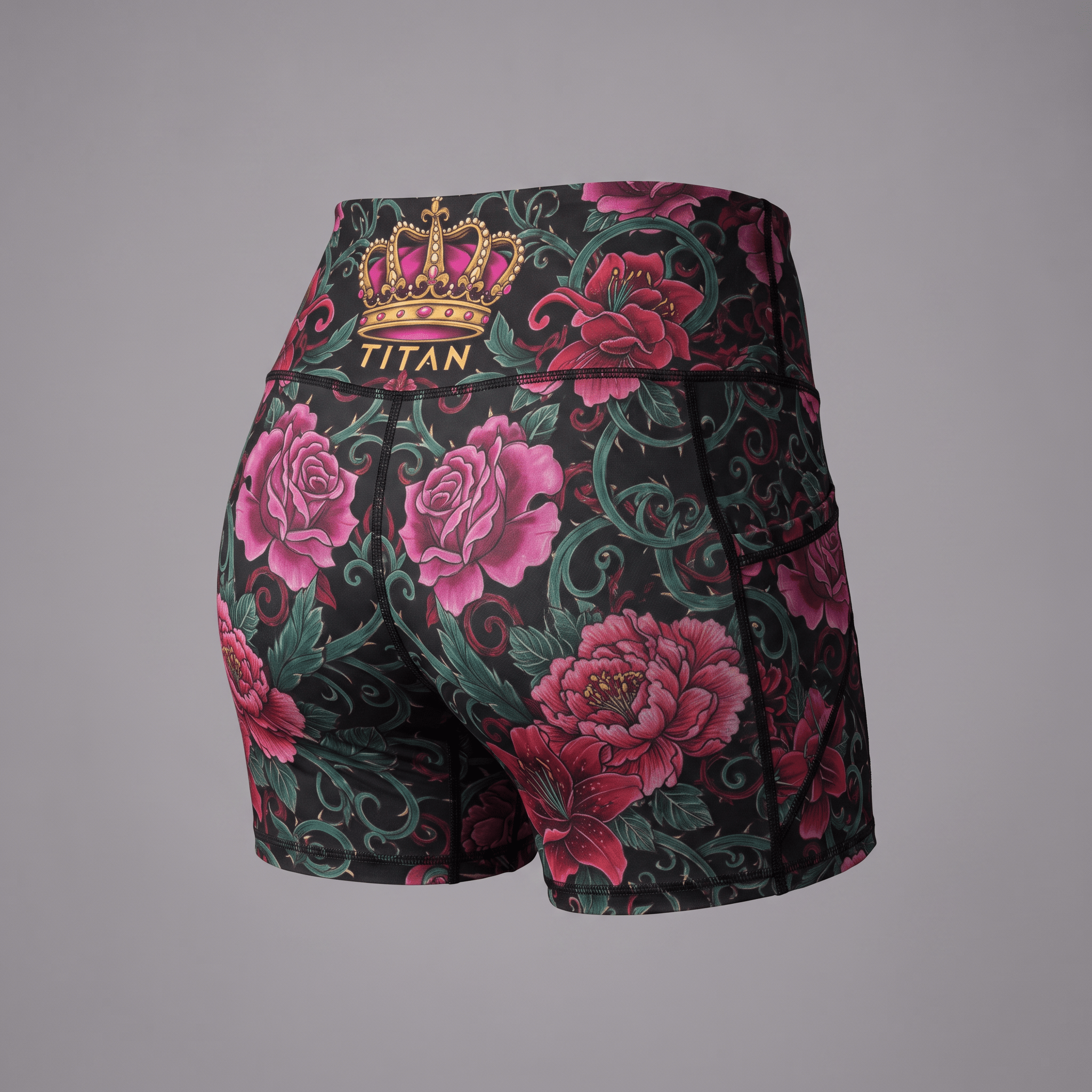 Titan athletic shorts with black, pink rose, and green floral tattoo print, back view.