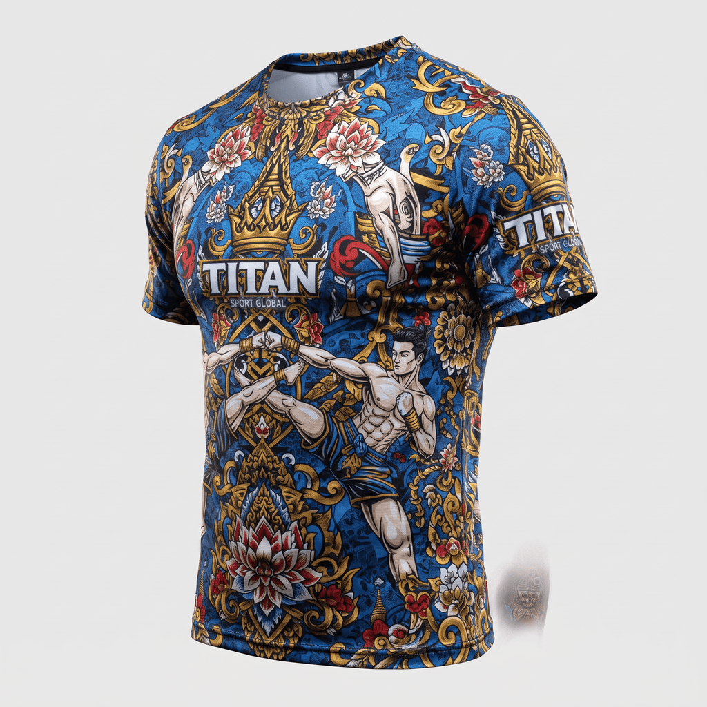Blue athletic t-shirt with ornate gold, white, and red Muay Thai graphics and Titan Sport Global branding.