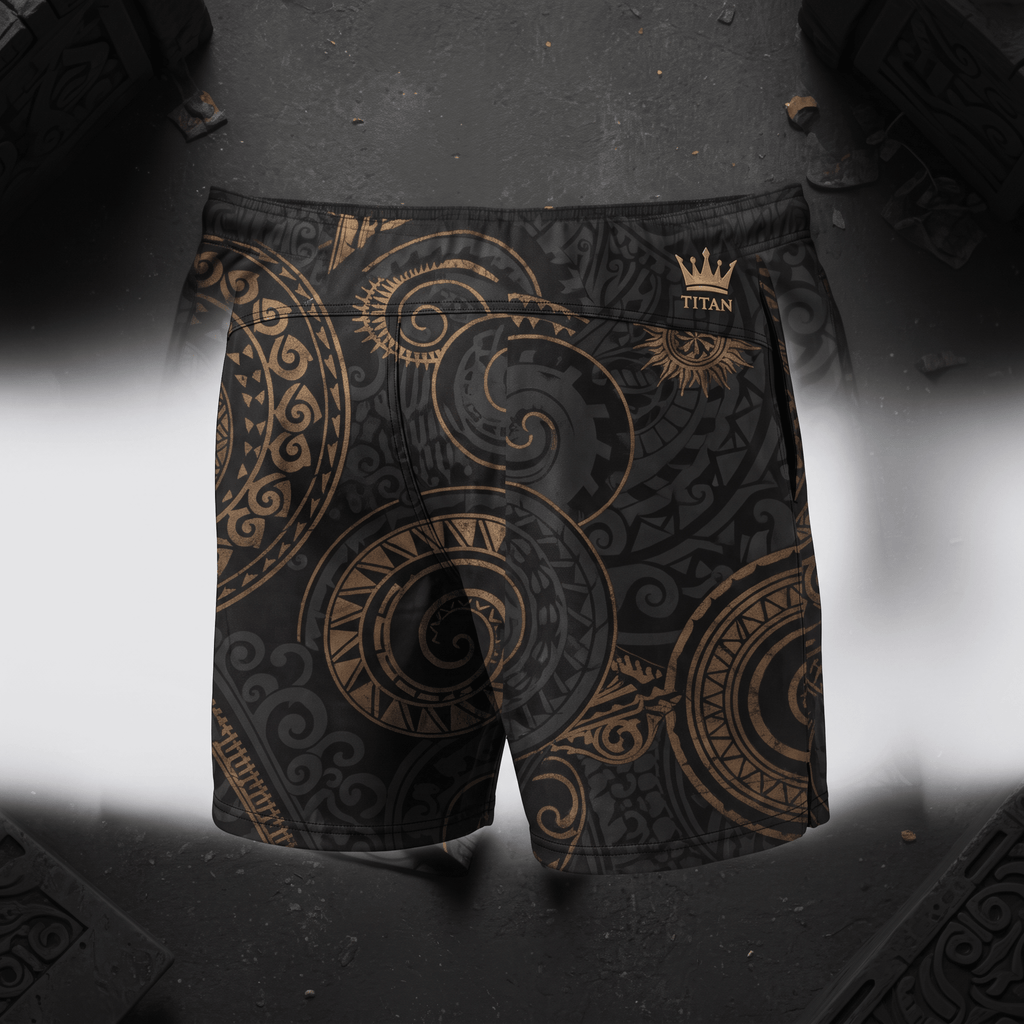 Black and gold Titan athletic shorts featuring a detailed tribal swirl pattern.