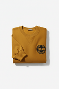 Victory gold crewneck sweatshirt with ribbed collar, V-inset, and circular black "TITAN" laurel patch.