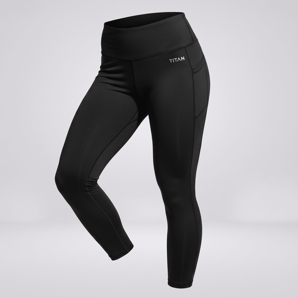 Black high-waisted athletic leggings with side pockets and Titan logo on grey background