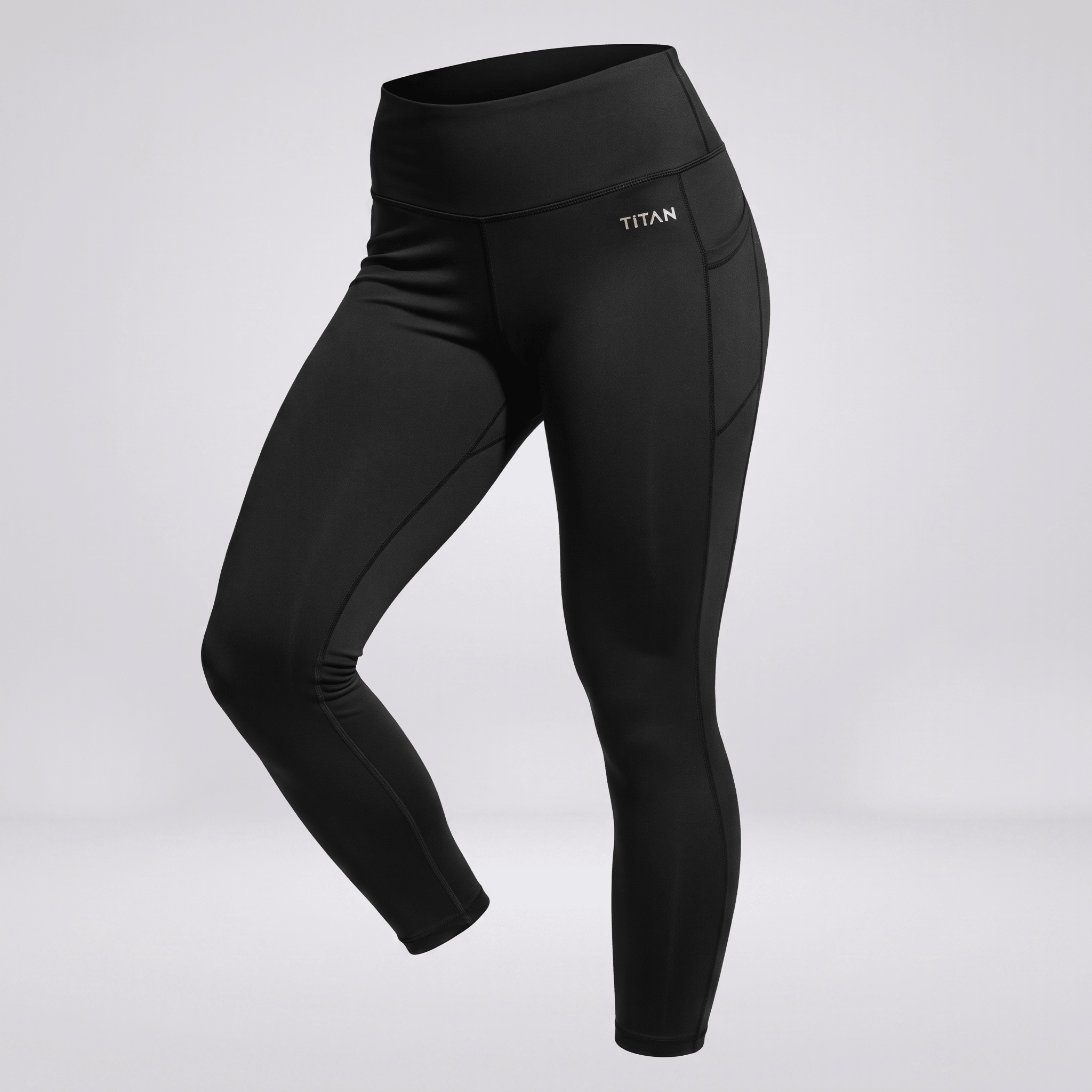 Black Titan high-waisted athletic cropped leggings with side pockets on a light background.