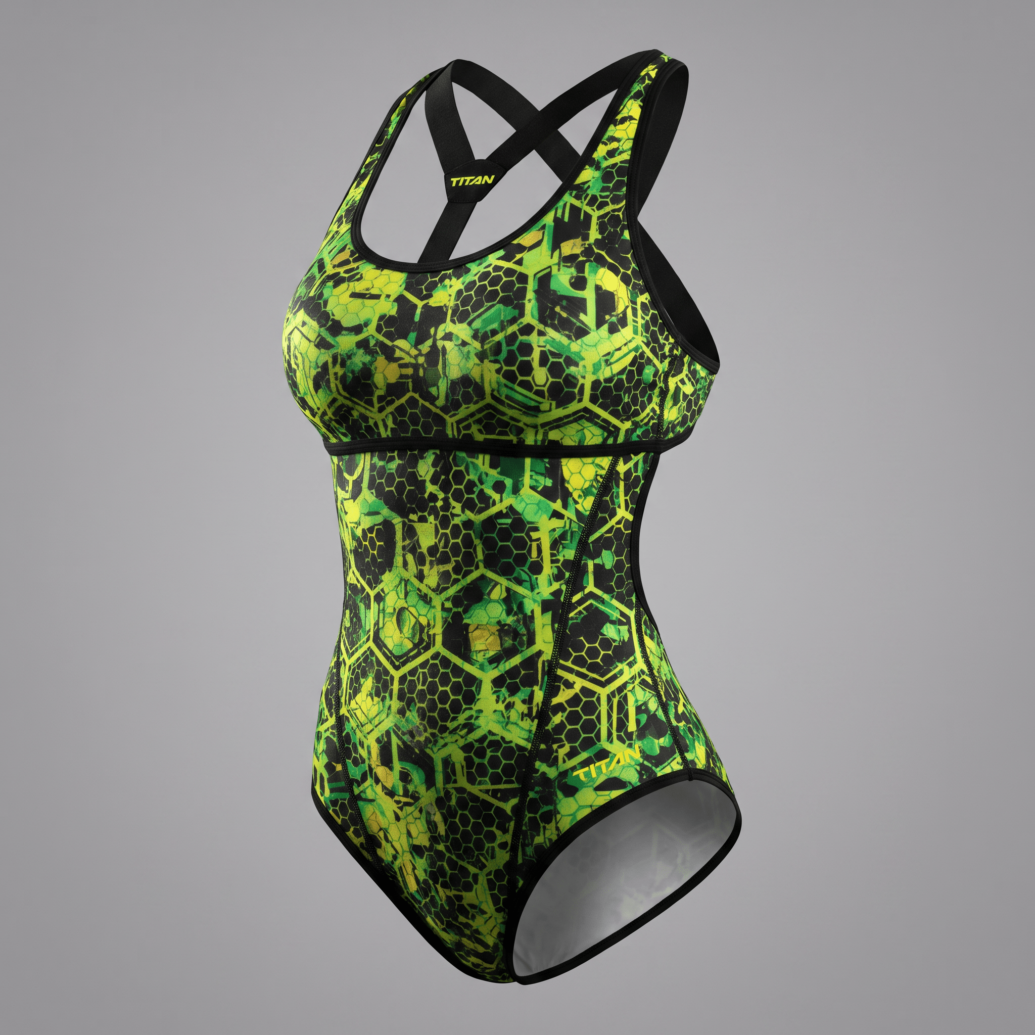 Green and black honeycomb pattern one-piece swimsuit with a crossback strap design displayed against a grey background.