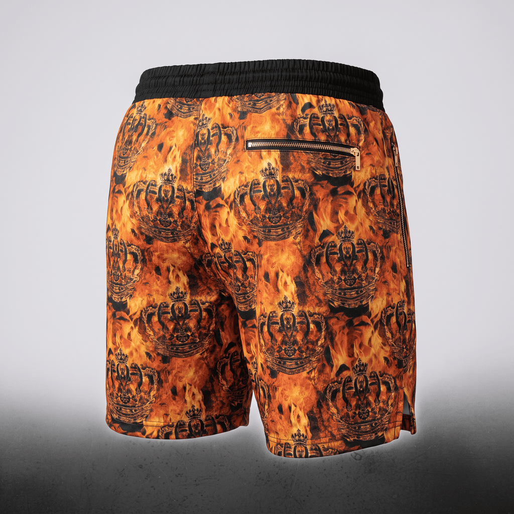 Back view of orange and black fire and crown print swim shorts with a black waistband and back zippered pocket.