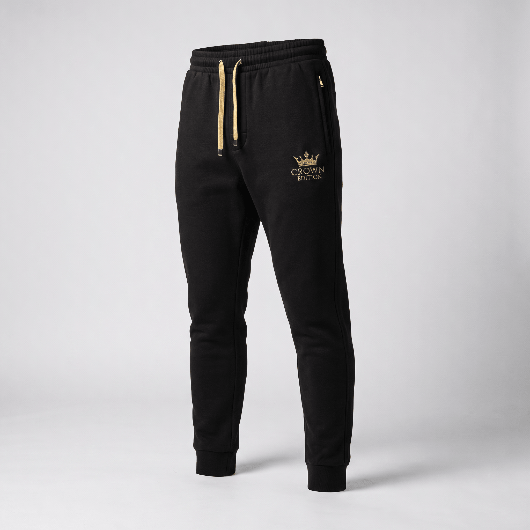 Black athletic sweatpants with gold drawstrings and Crown Edition logo on left thigh.