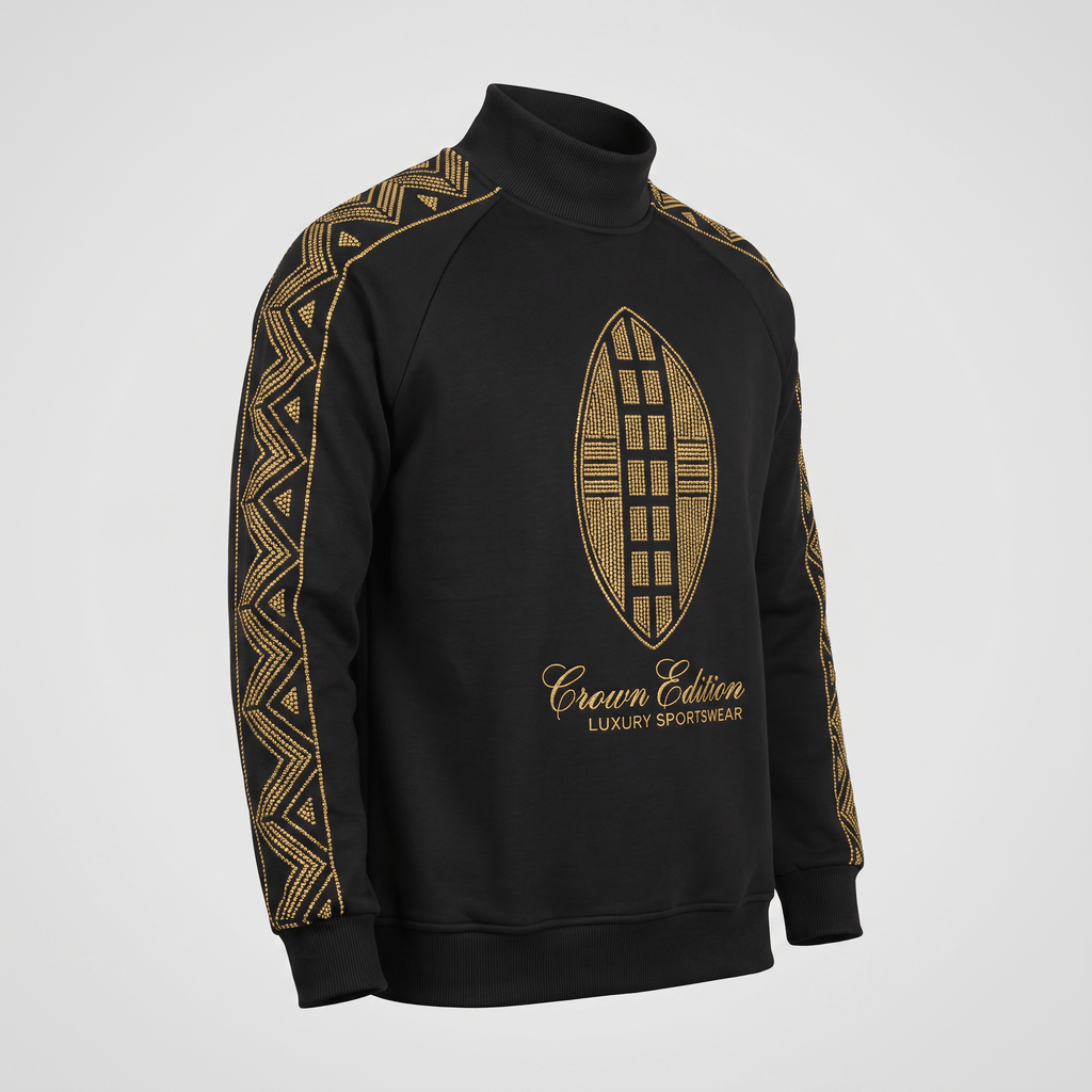 Black turtleneck sweatshirt with gold rhinestone tribal pattern on sleeves and shield logo on chest.
