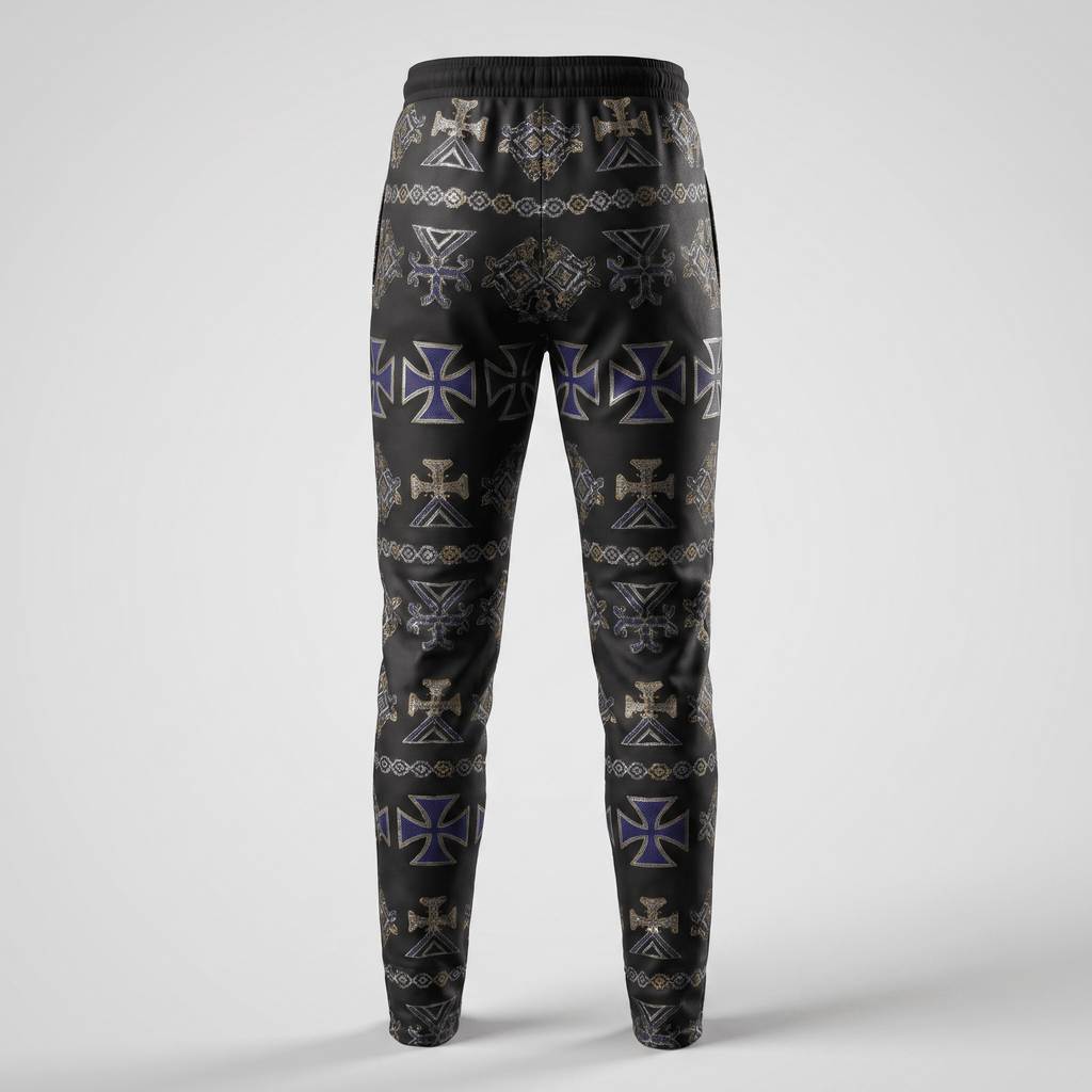 Back view of black sweatpants with a gothic purple and gold cross pattern against a plain background.