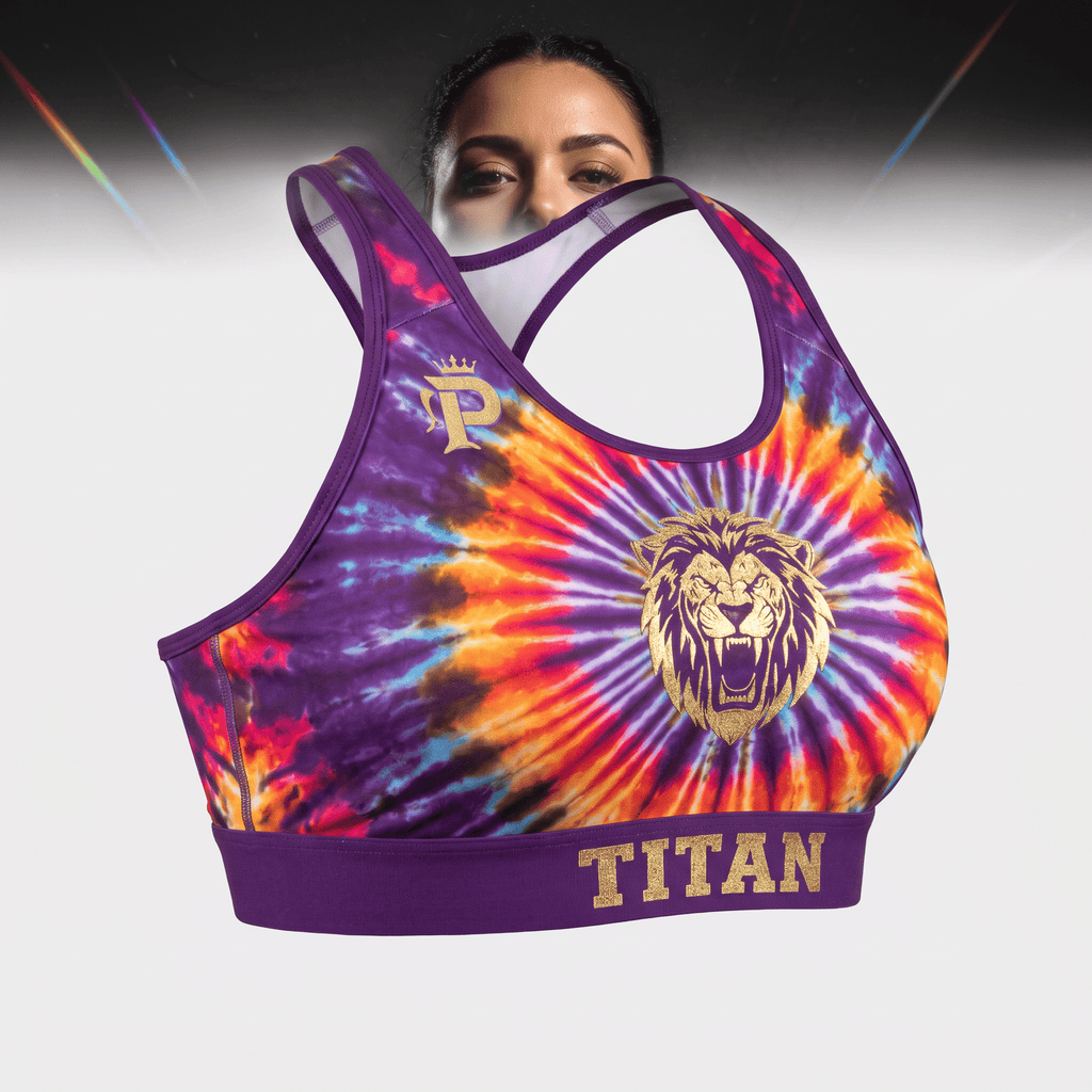 Purple tie-dye sports bra with gold lion graphic, Titan text on band, and a matching headband worn by a model.