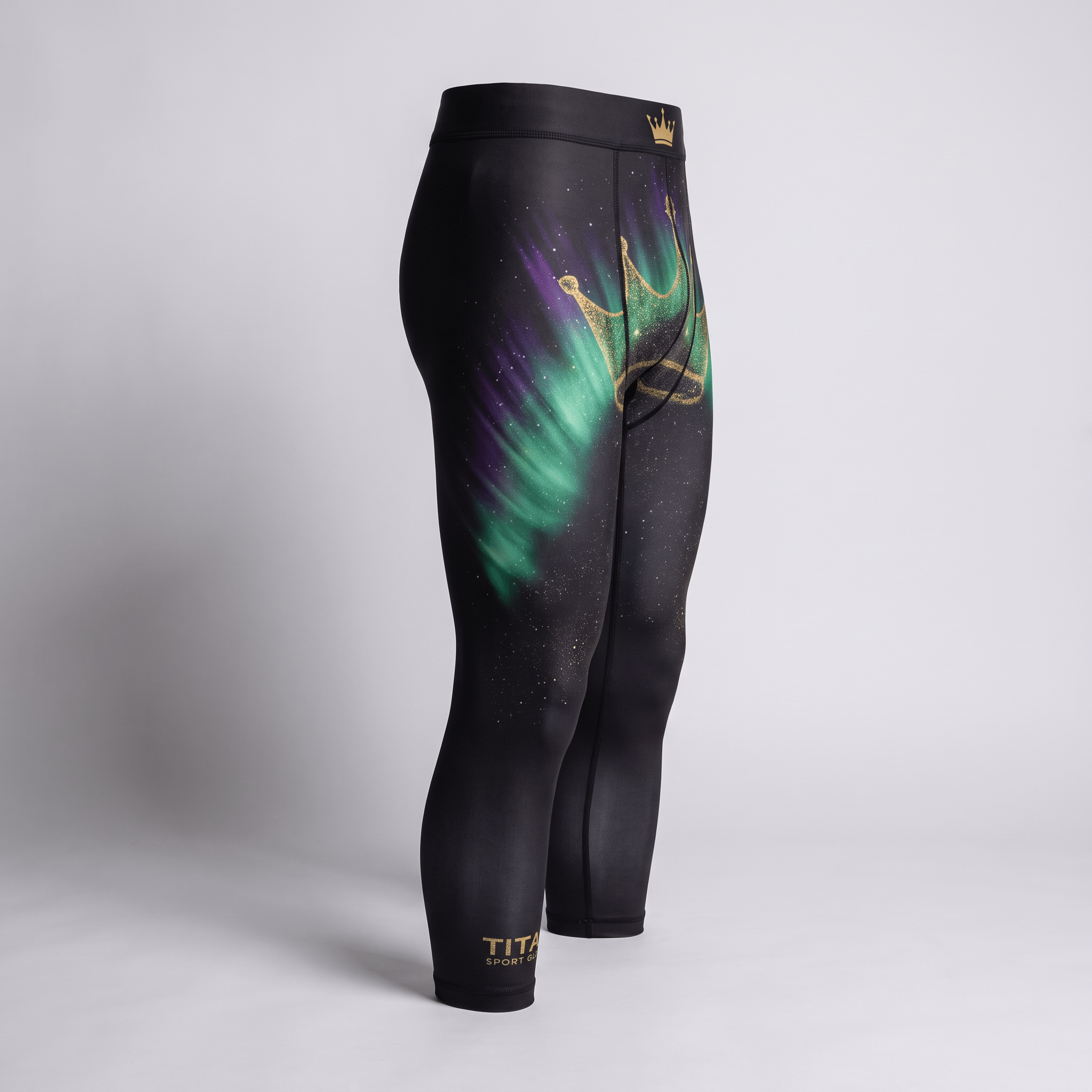Black athletic leggings with green and purple northern lights graphic and a gold crown print on a light gray background.