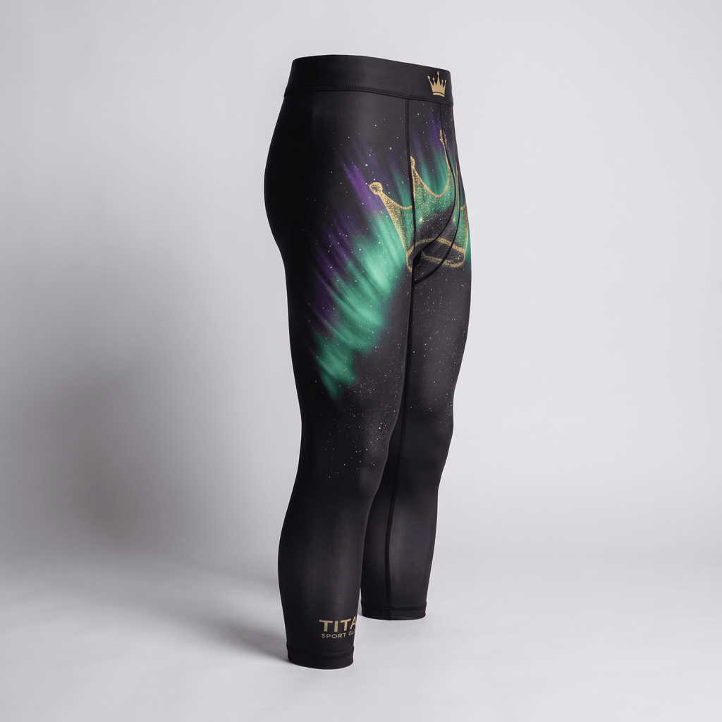 Black athletic spats featuring green and purple northern lights and a gold glitter crown graphic.
