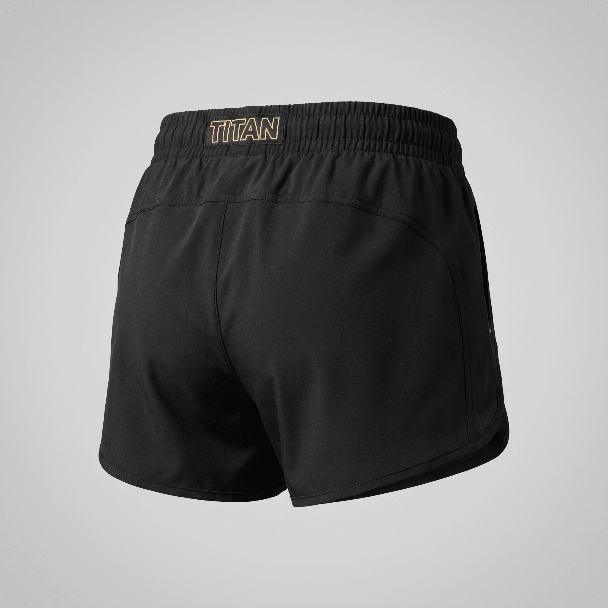 Rear view of black athletic shorts featuring a gold Titan logo on the elastic waistband.