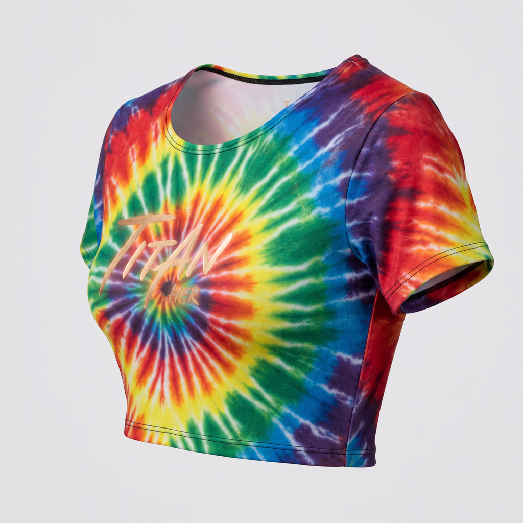 Rainbow tie-dye crop top with short sleeves and gold Titan Her logo on the front.