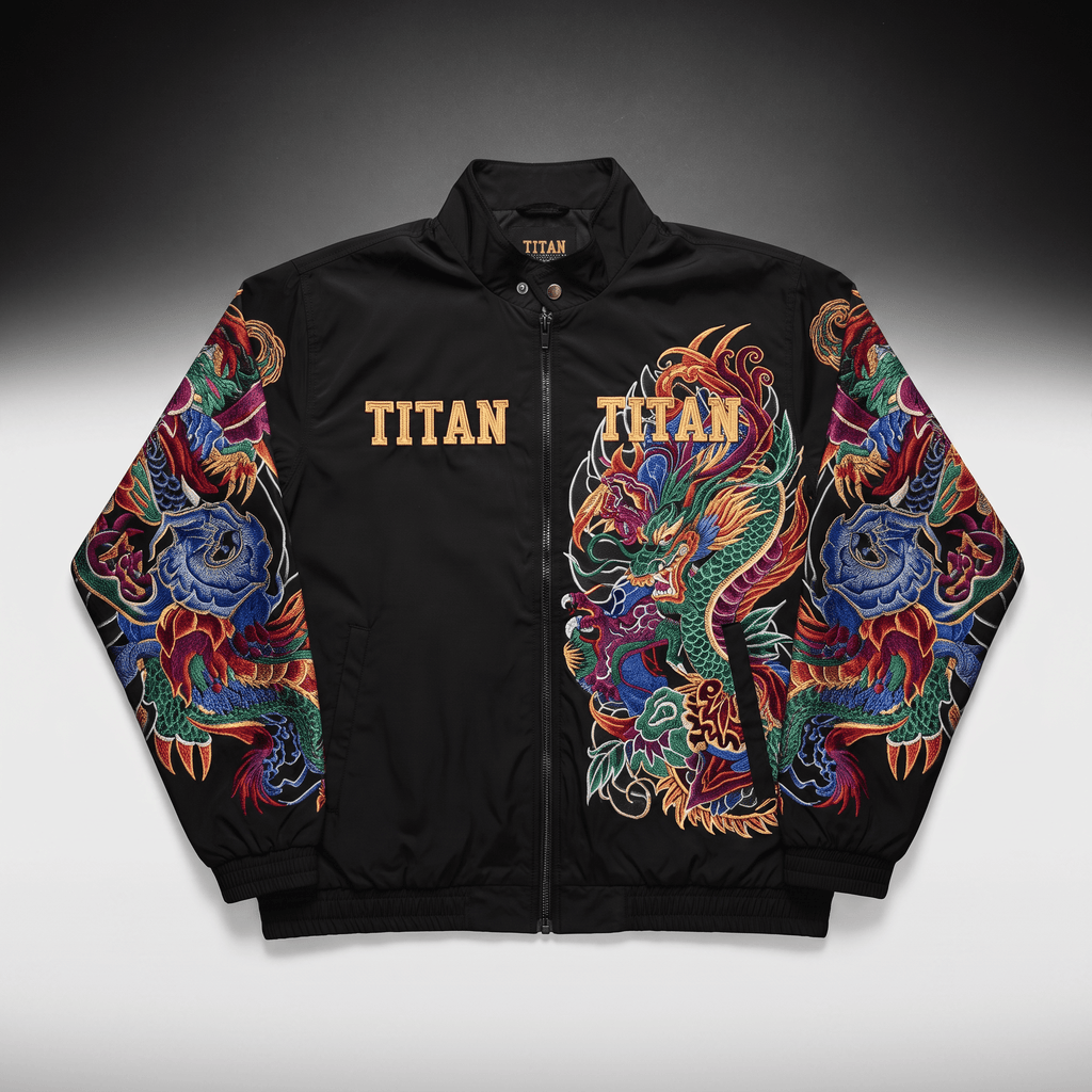 Black bomber jacket featuring colorful embroidered dragon art and gold Titan text branding.