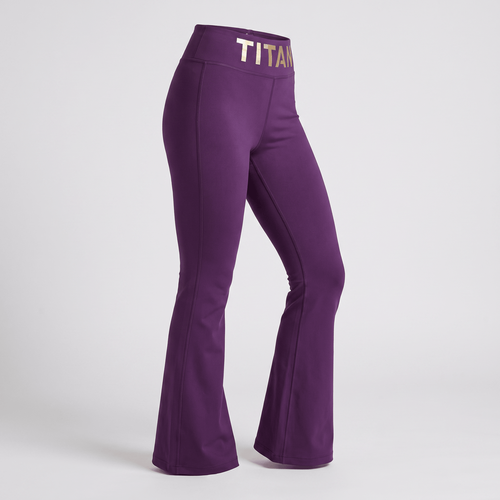 Purple flare yoga pants with a wide gold metallic TITAN waistband on a plain background.