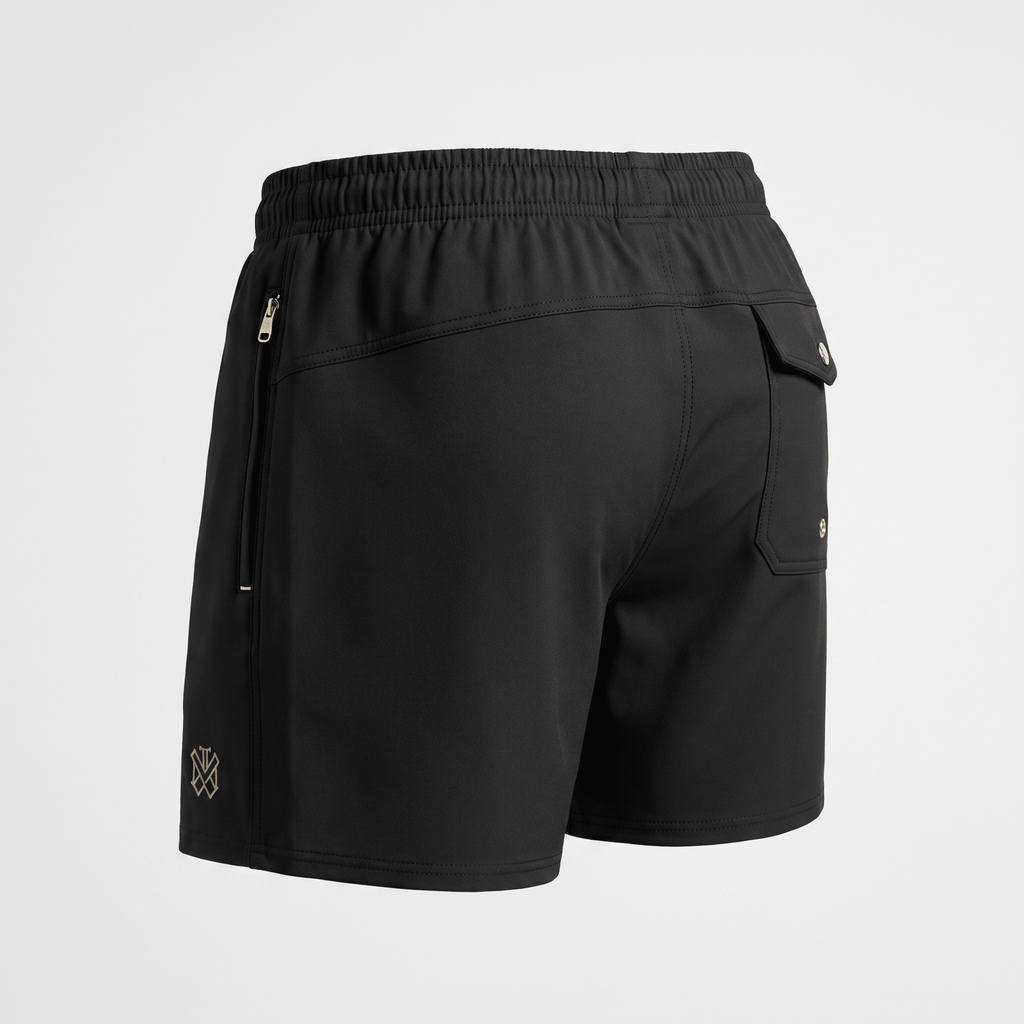 Back view of black athletic shorts featuring an elastic waistband, zipper pockets, and a buttoned rear pocket.