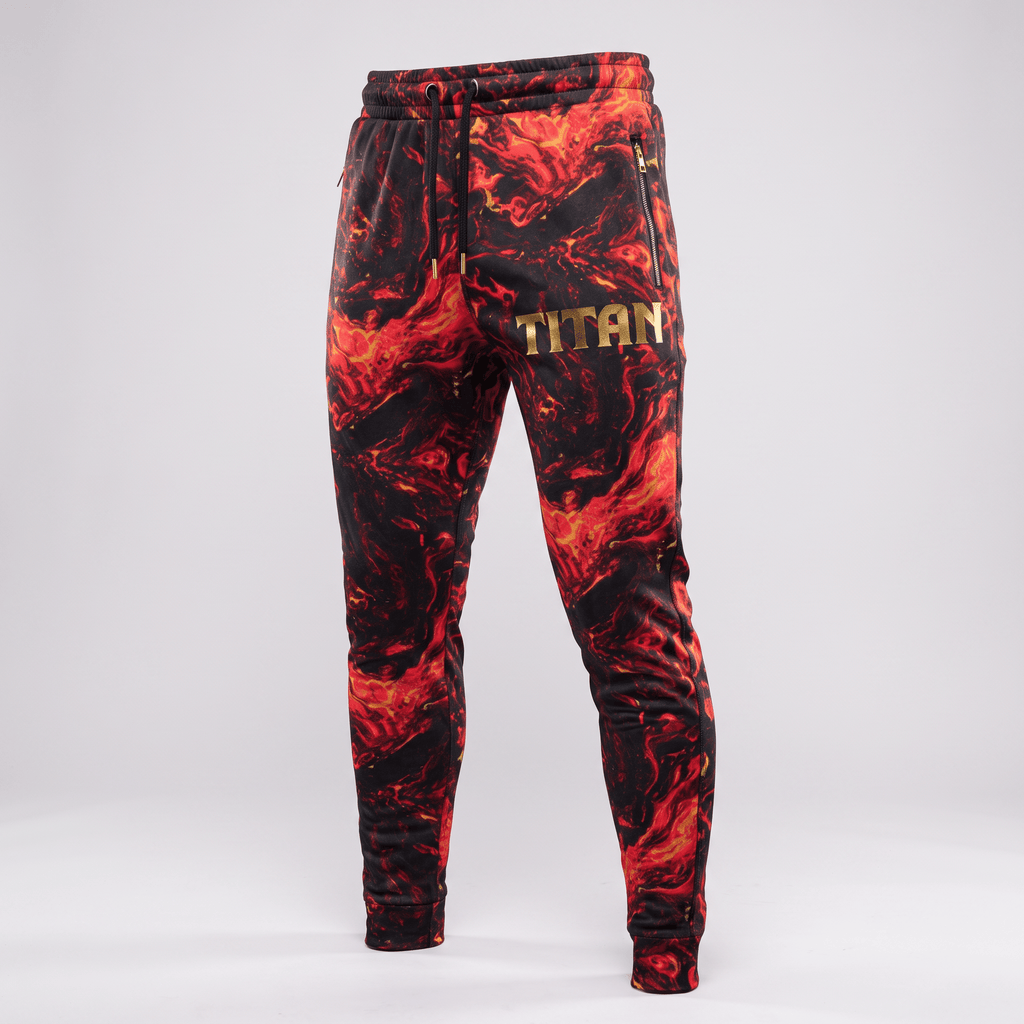 Red and black lava print sweatpants with gold Titan logo and zippered pockets on a light background.
