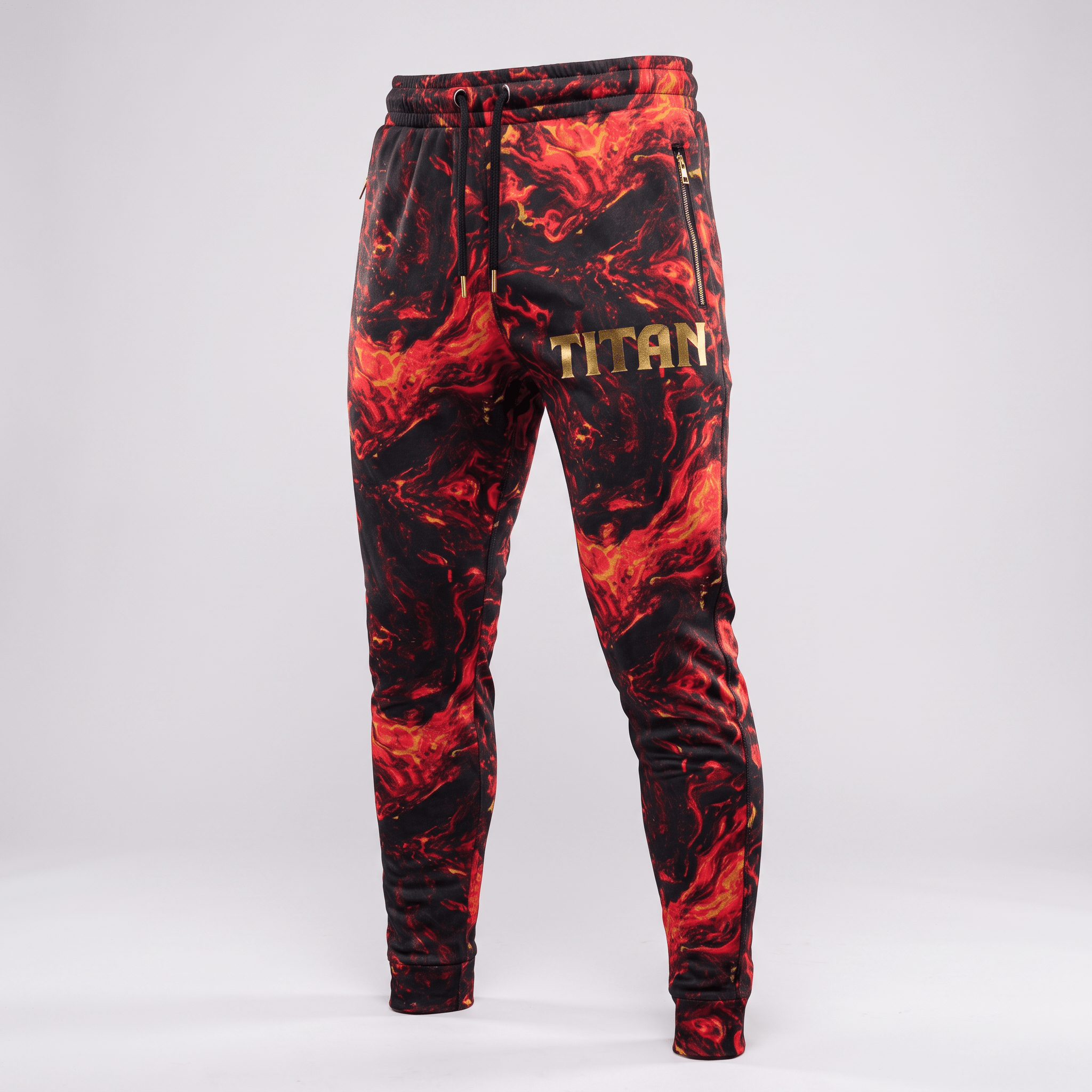 Red and black lava print sweatpants with gold Titan logo and zippered pockets on a light background.