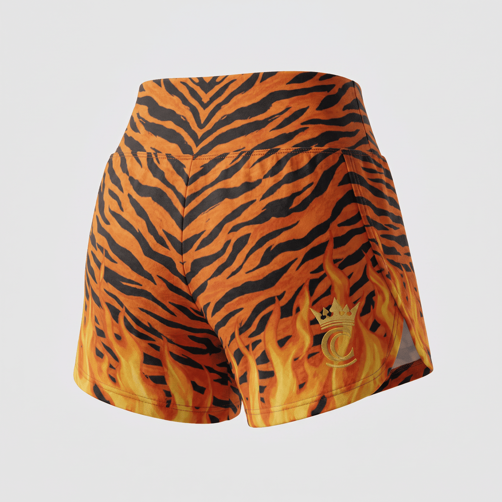 Back view of athletic shorts featuring an orange and black tiger stripe pattern with yellow flames and a gold crown logo.