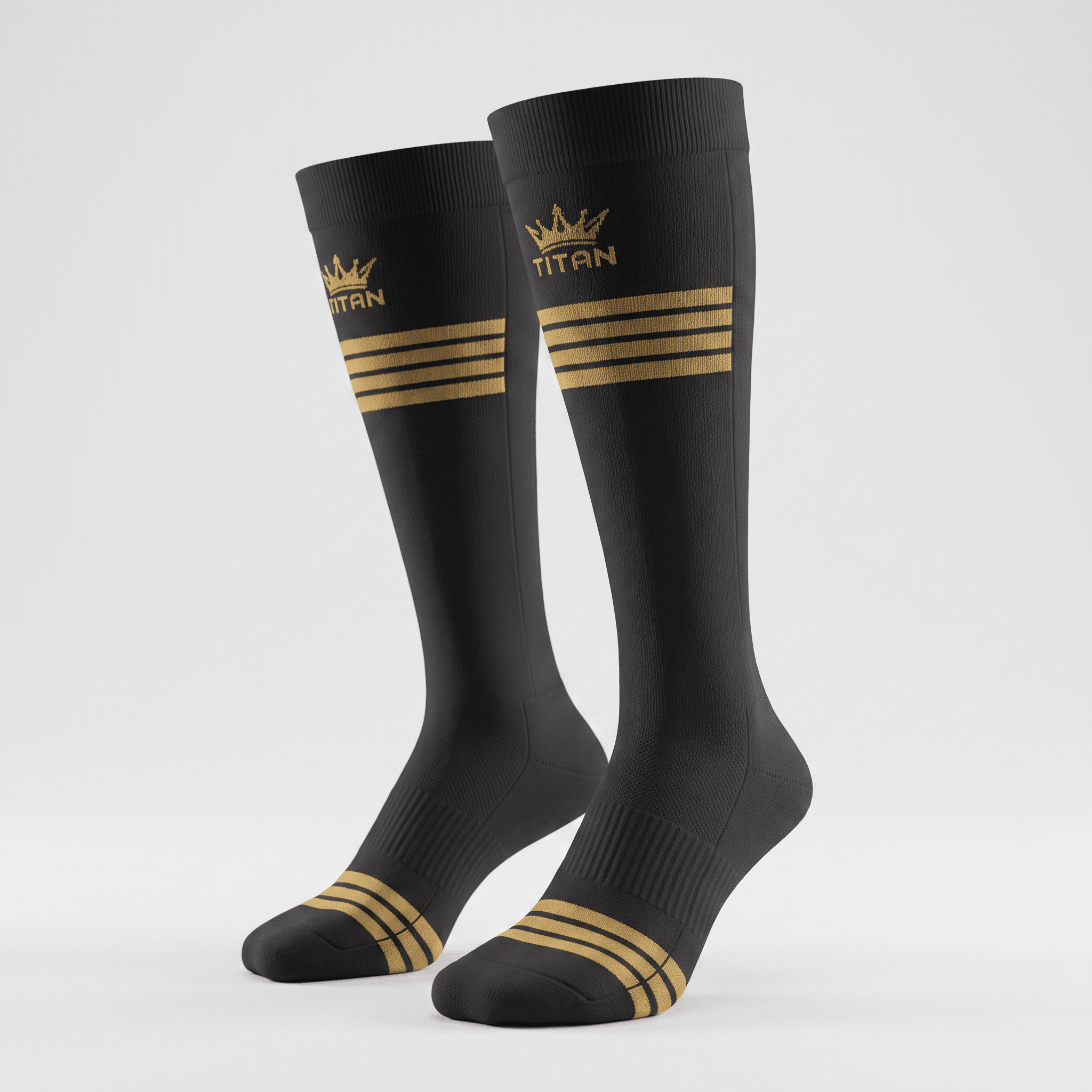 Black athletic crew socks with gold Titan crown logo and triple stripe design on a light gray background.