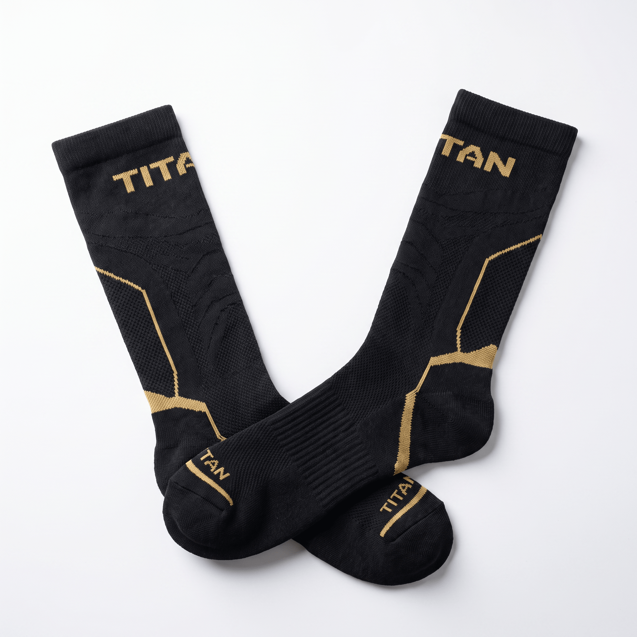 Black Titan athletic socks with gold branding and compression details on white background.
