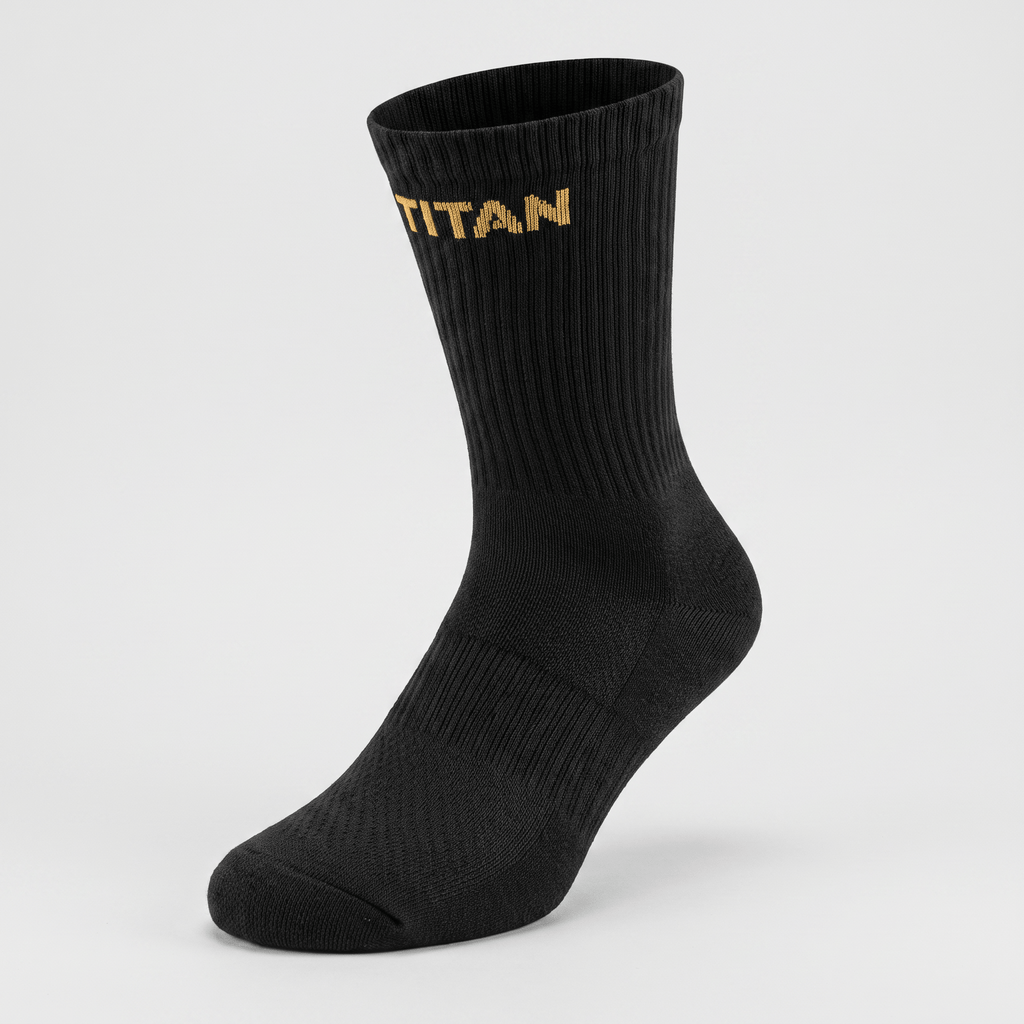 Black athletic crew sock with ribbed leg and gold Titan logo text on the cuff against a light background.