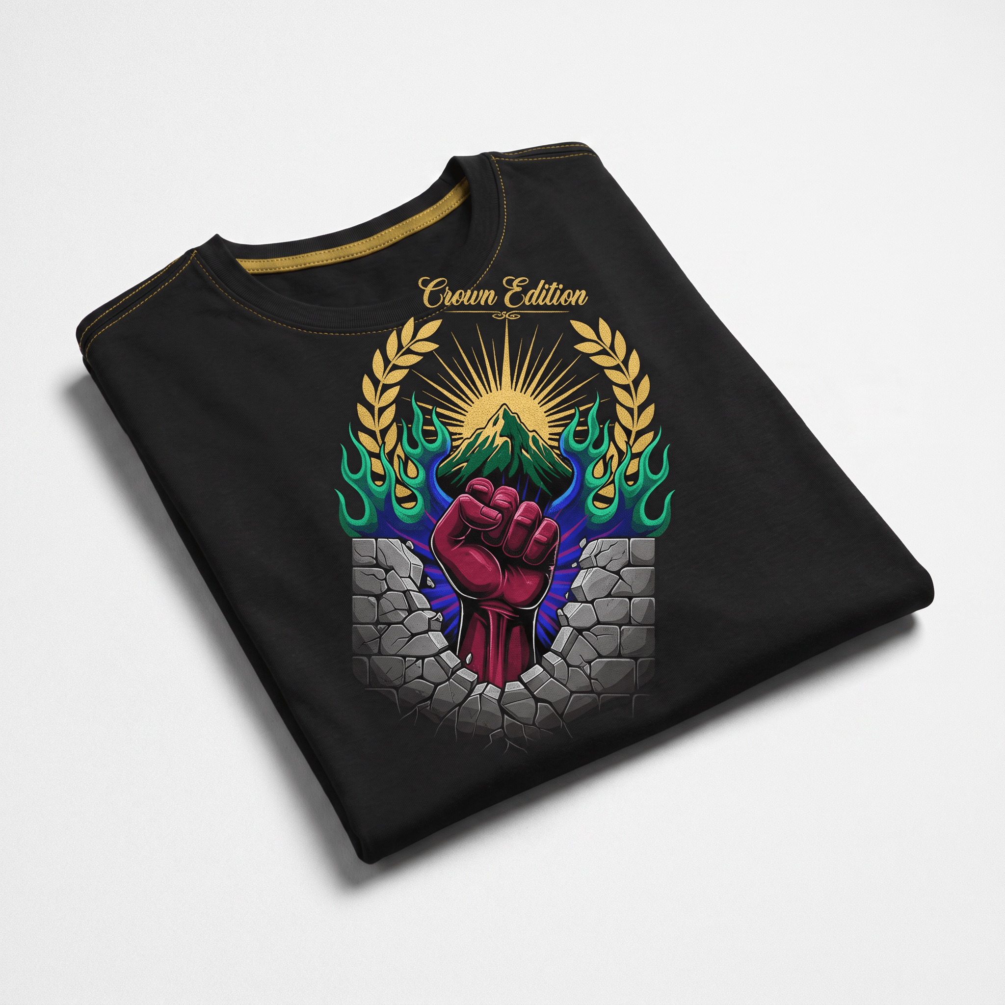 Folded black t-shirt with a graphic of a red fist breaking through a stone wall beneath a mountain and sun.
