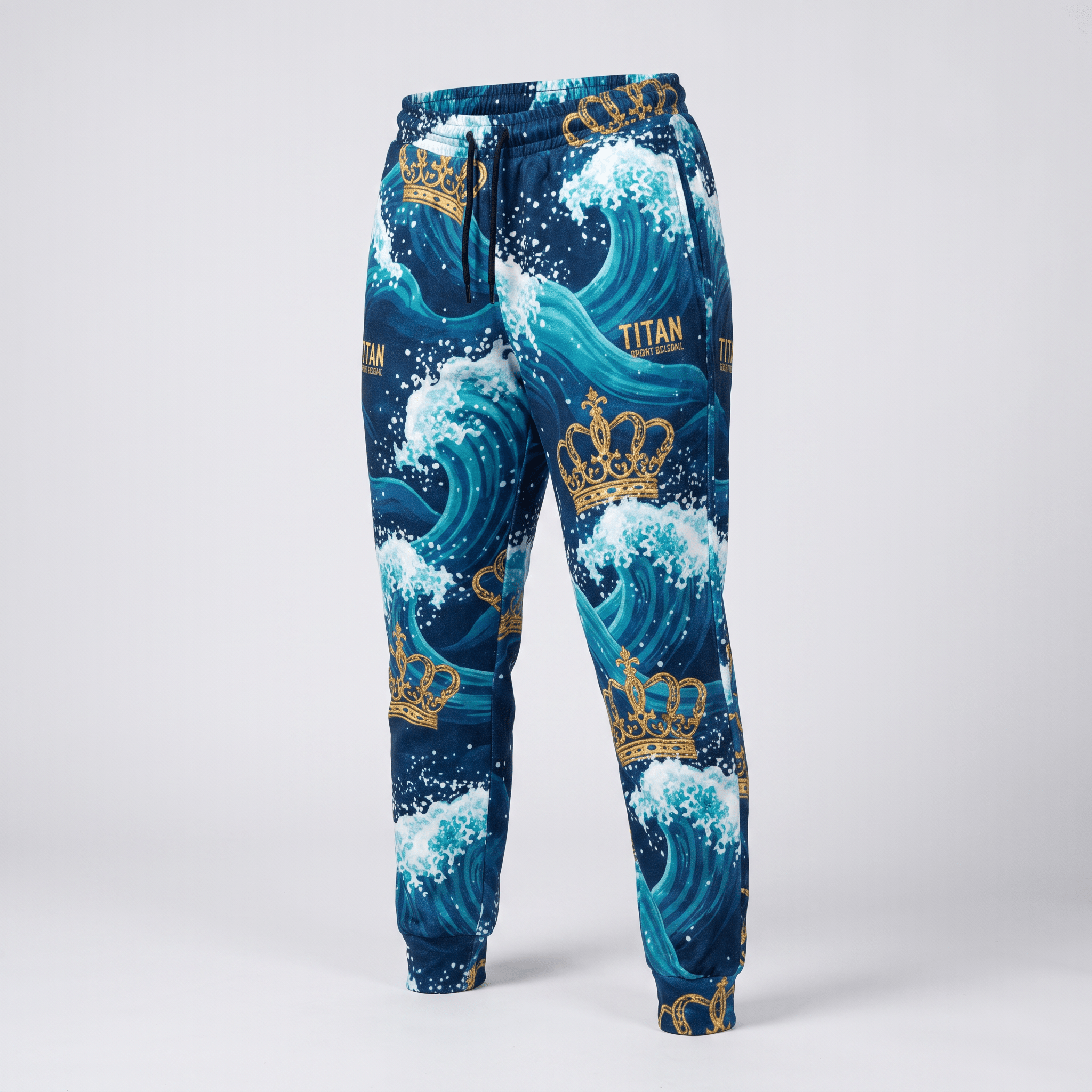 Blue sweatpants with a gold crown and turquoise ocean wave graphic print, featuring cuffed ankles and an adjustable drawstring.