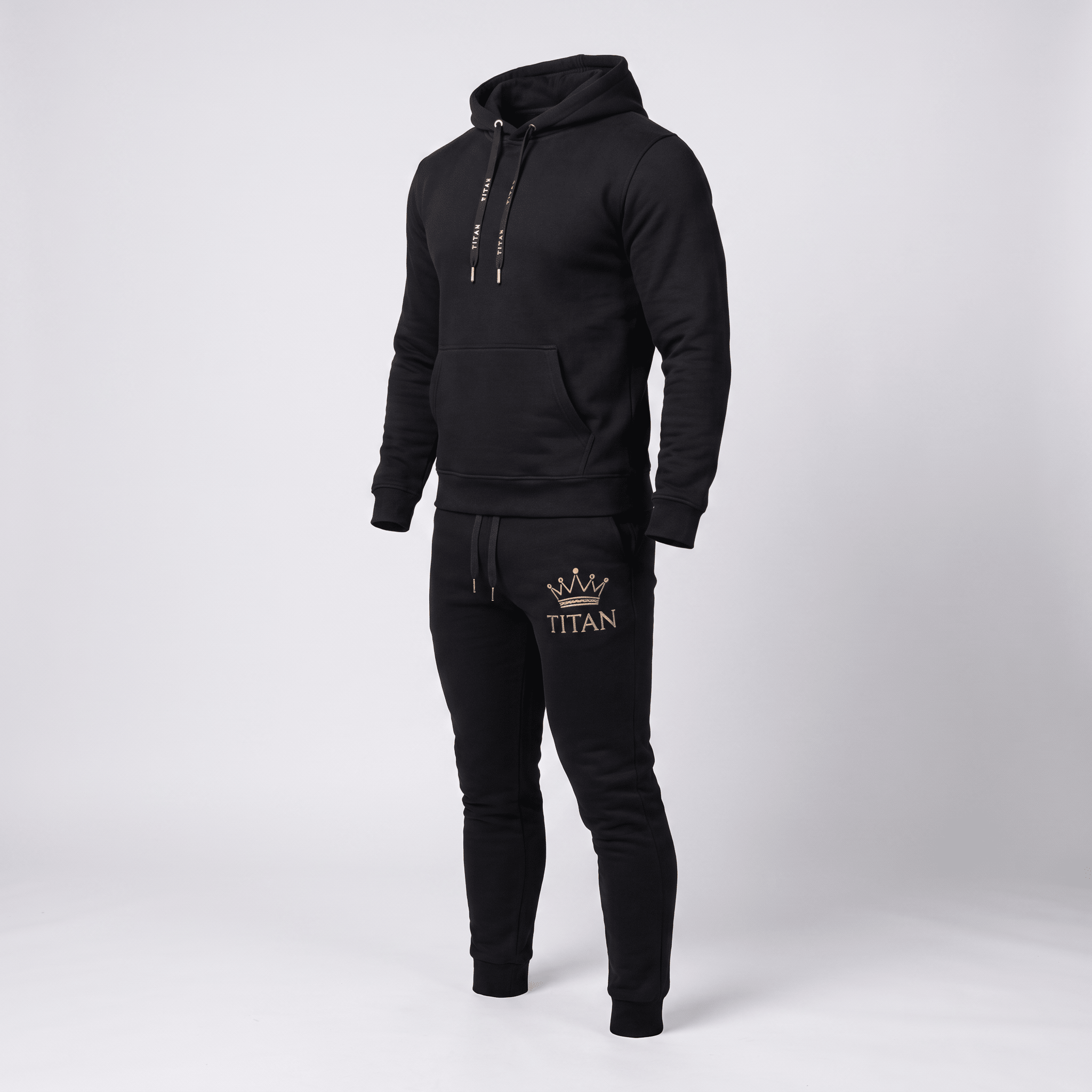 Black athletic tracksuit featuring a hoodie and joggers with gold Titan crown logo.