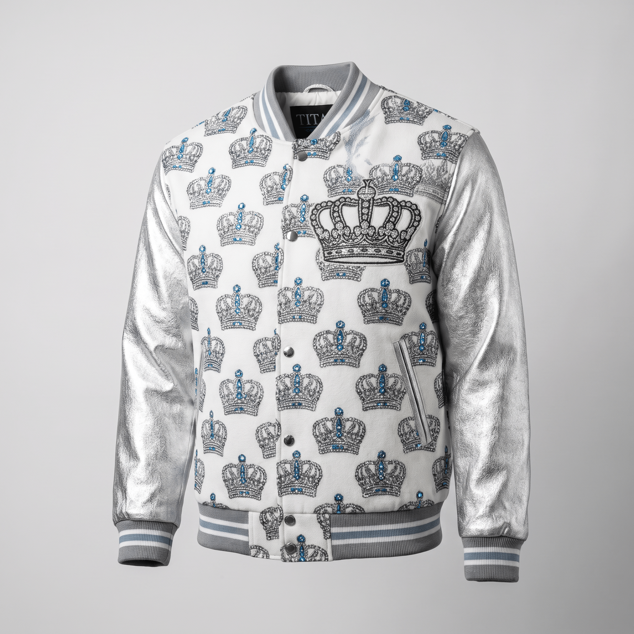 White varsity jacket with metallic silver sleeves, blue crystal crown print, and large embroidered chest crown.