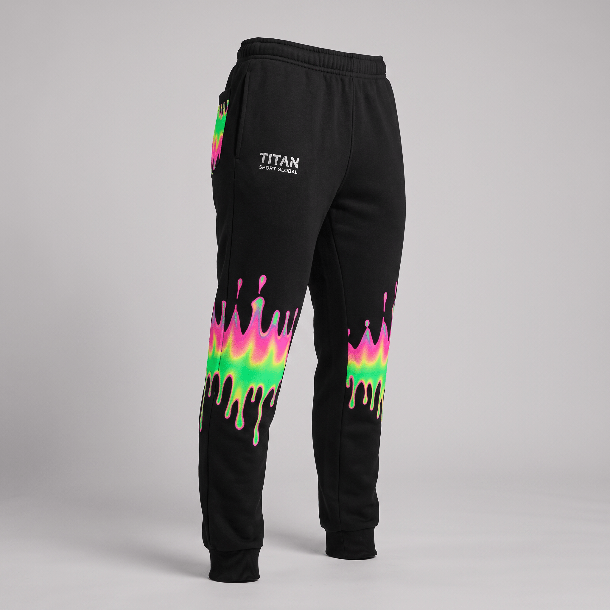 Black sweatpants with neon pink and green drip graphics, cuffed ankles, and Titan Sport Global logo.