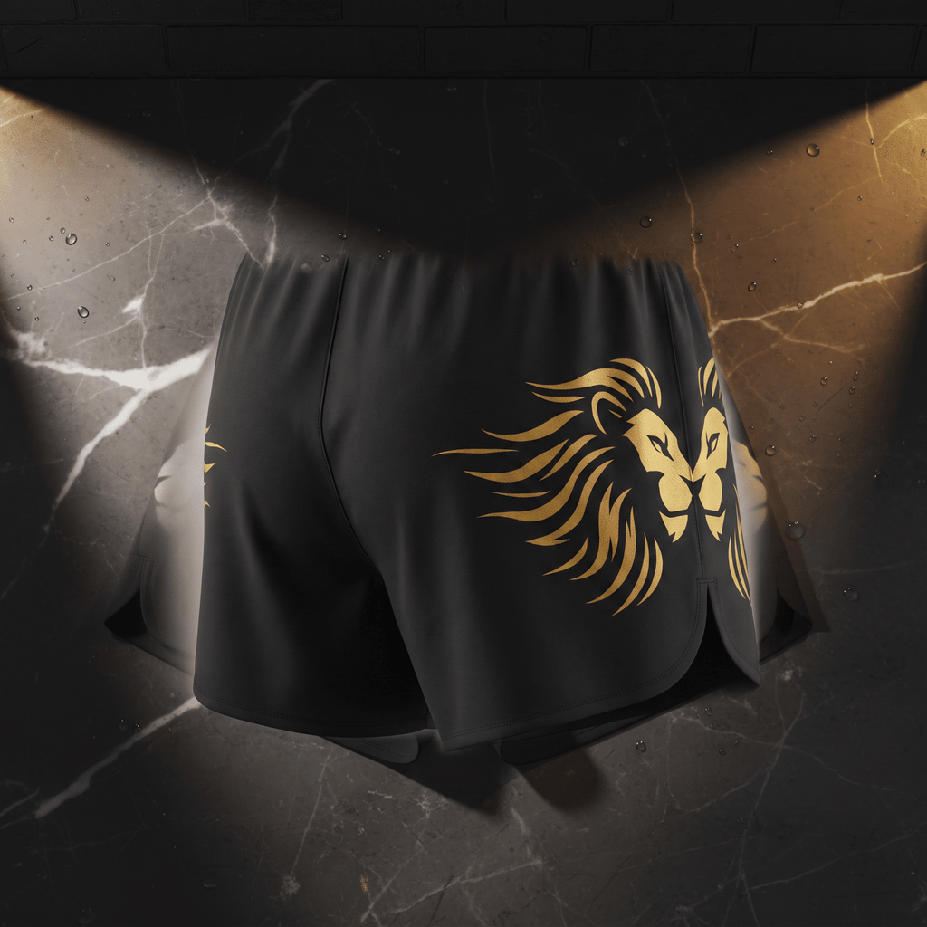Black athletic shorts featuring a gold lion graphic on the side against a dark marble backdrop.