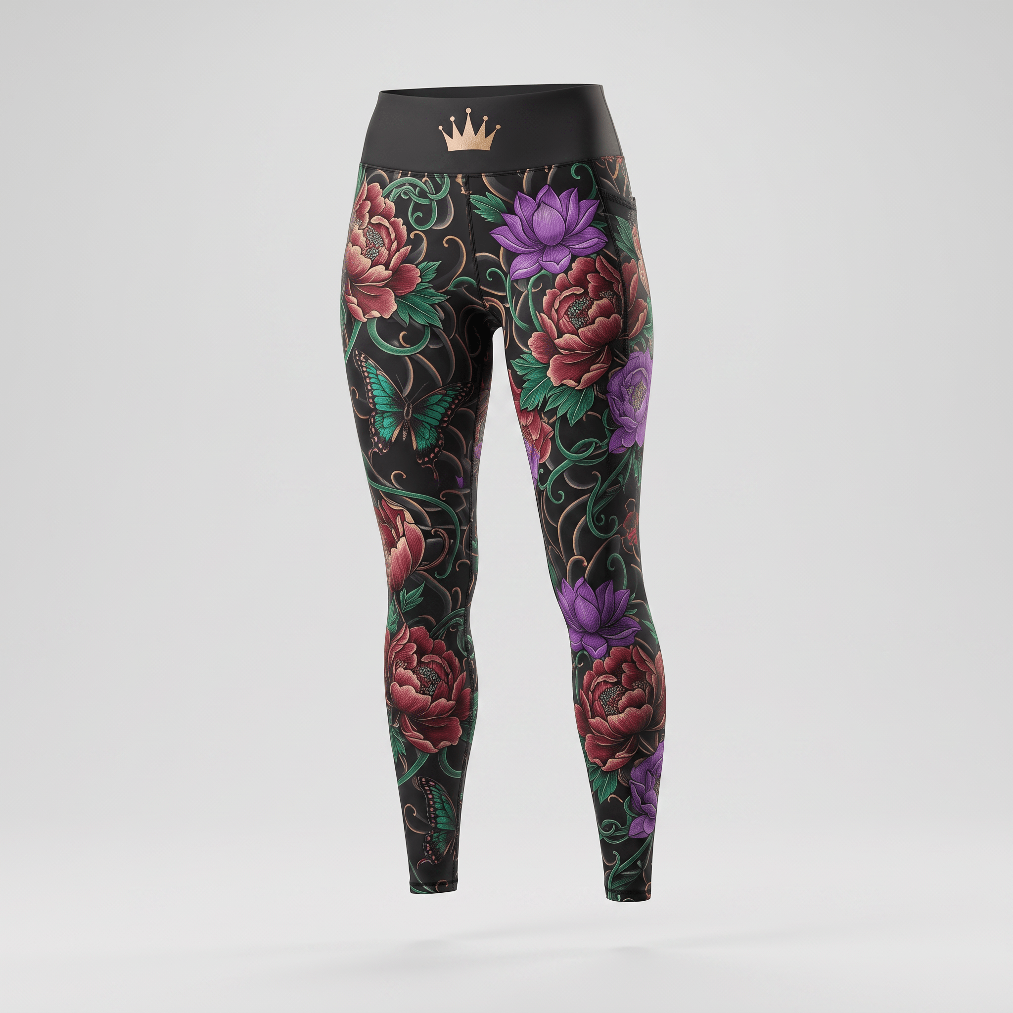 Black high-waisted leggings featuring colorful floral and butterfly tattoo print with rose gold crown logo on waistband.