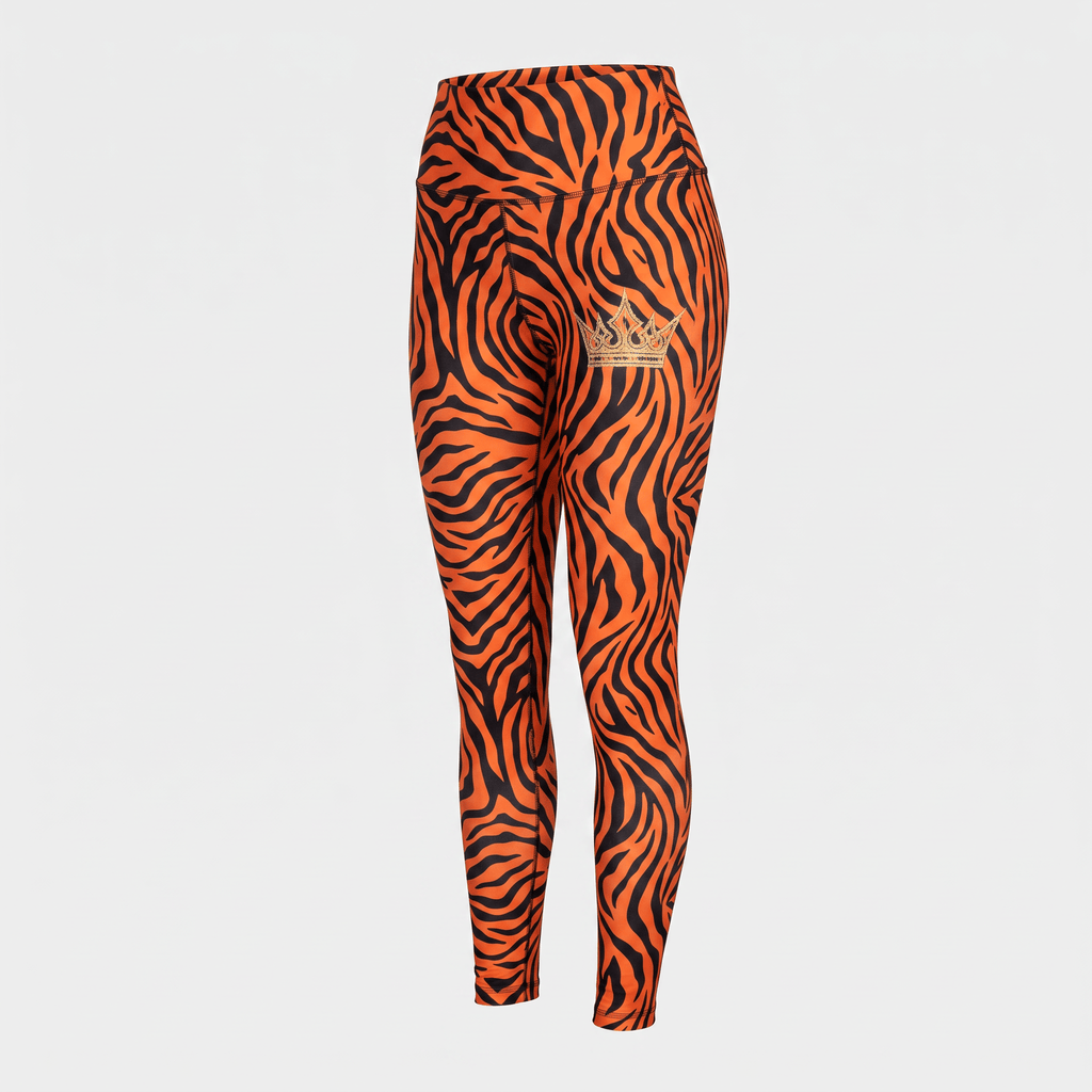 High-waisted orange and black tiger stripe leggings with a gold crown logo on the left hip.