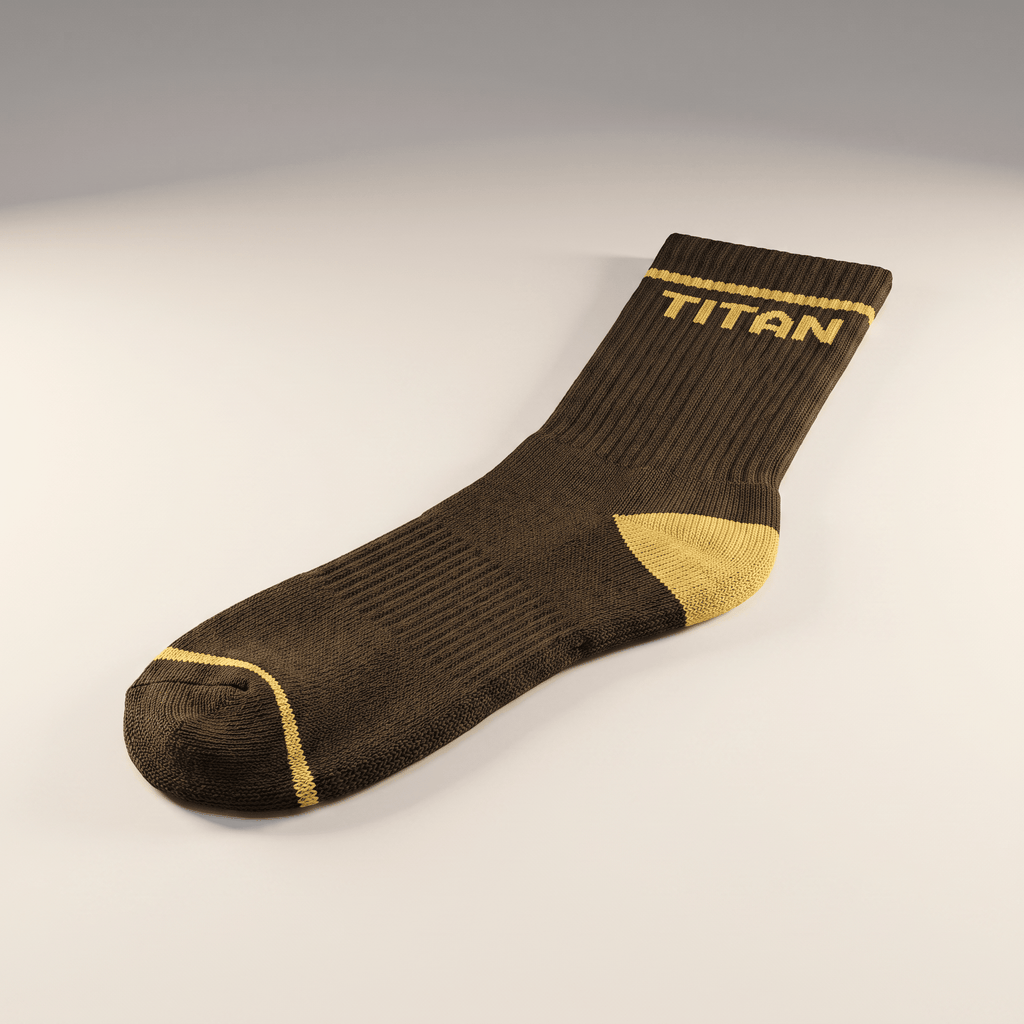 Brown athletic crew sock with yellow heel, toe stripe, and TITAN logo on cuff.