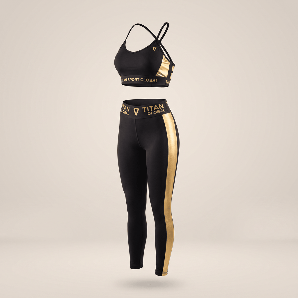Black athletic sports bra and matching high-waisted leggings set with metallic gold side stripes and Titan Global branding.