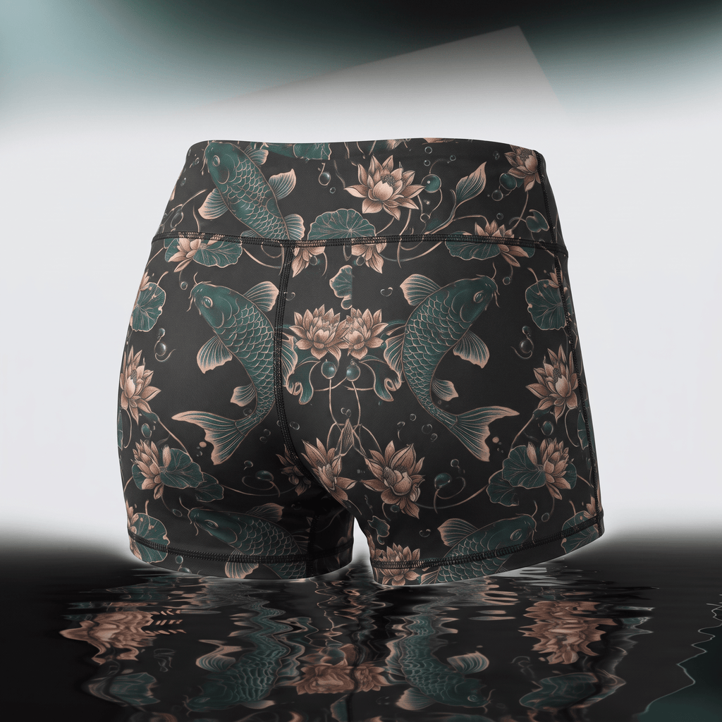 Black athletic shorts featuring a teal koi fish and lotus flower print, shown from the back.