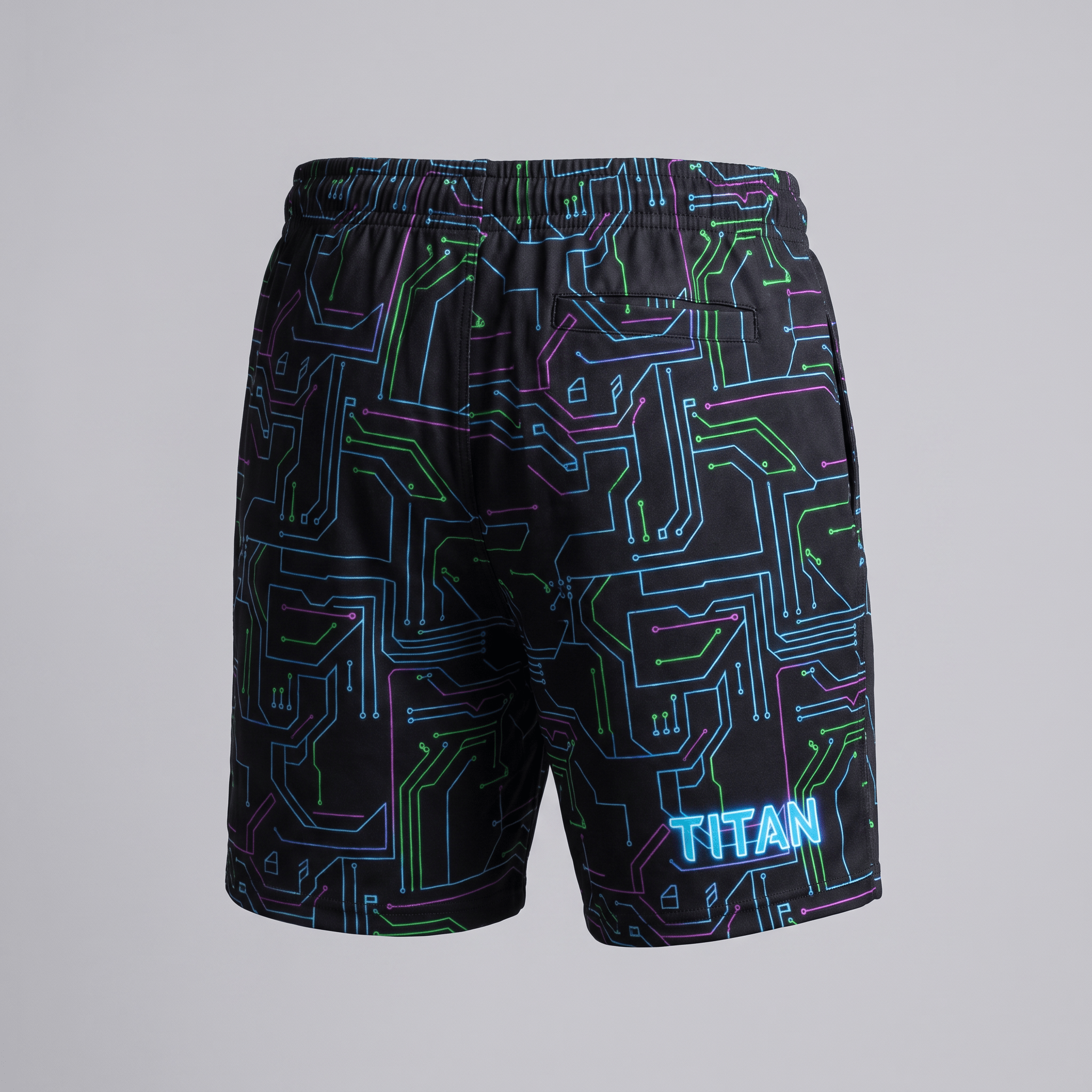Back view of black athletic shorts with neon circuit board pattern and Titan logo on the leg.