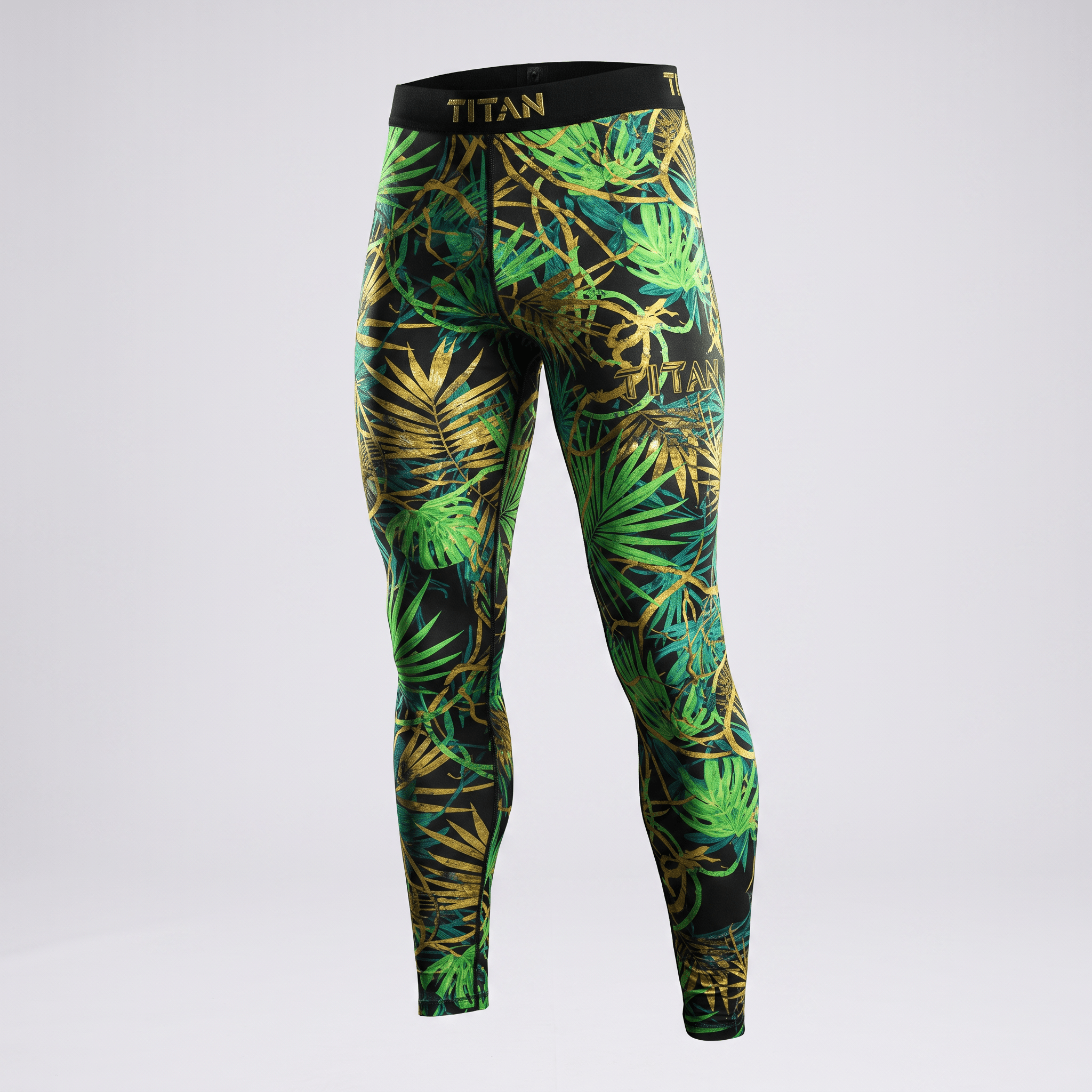 Titan athletic leggings featuring a black, green, and gold tropical leaf print with a black waistband.