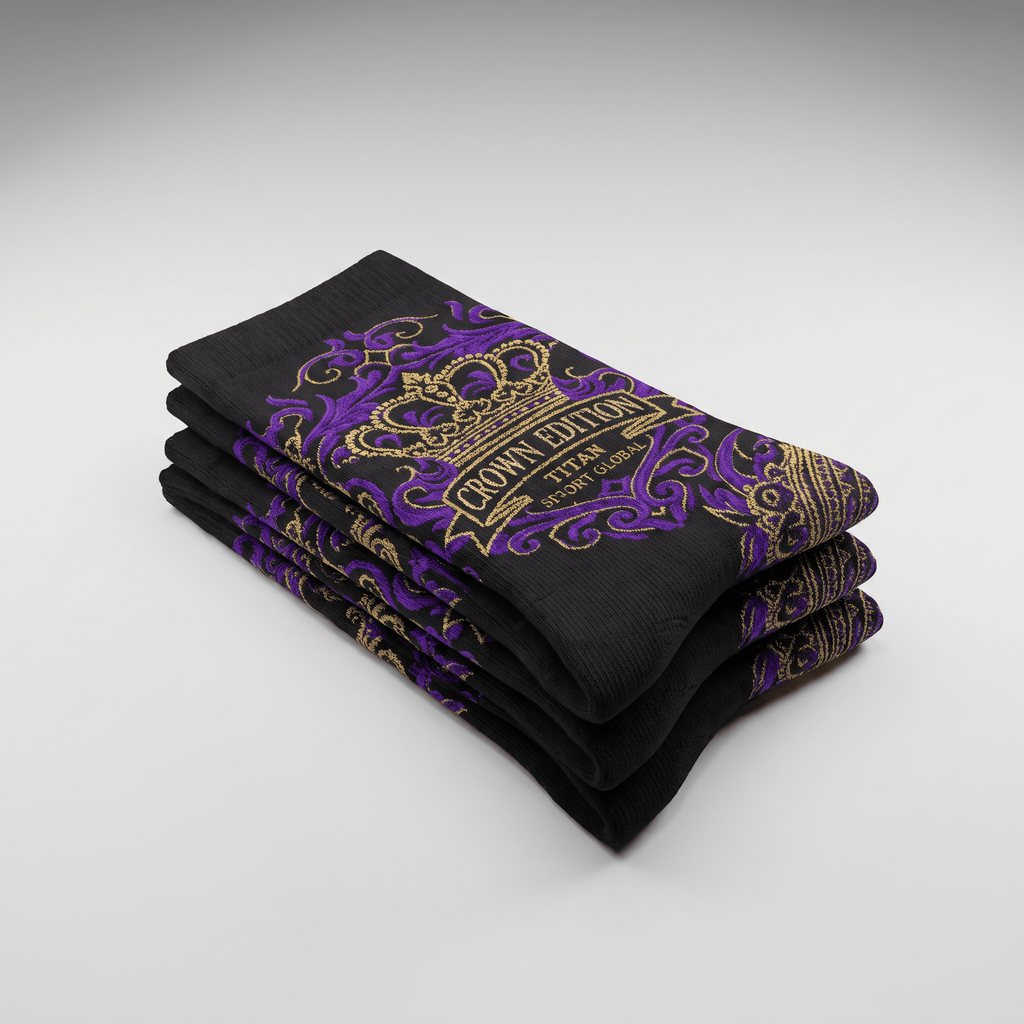 A folded stack of black crew socks featuring purple and gold crown edition branding.