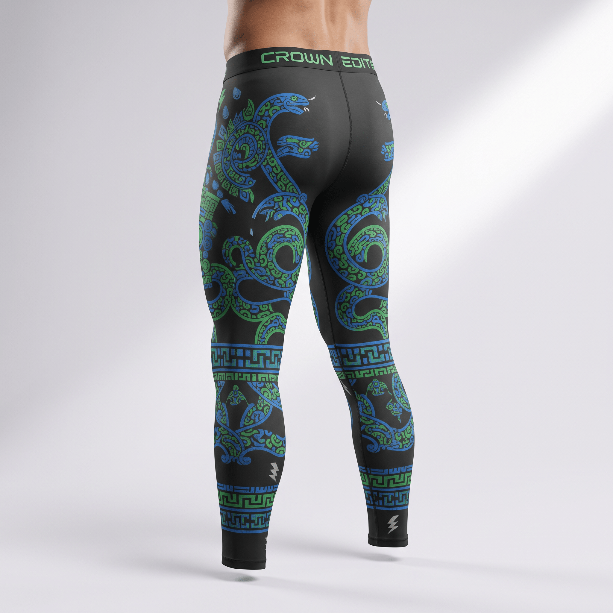 Rear view of a man wearing black athletic leggings with blue and green snake prints and Crown Edition waistband.