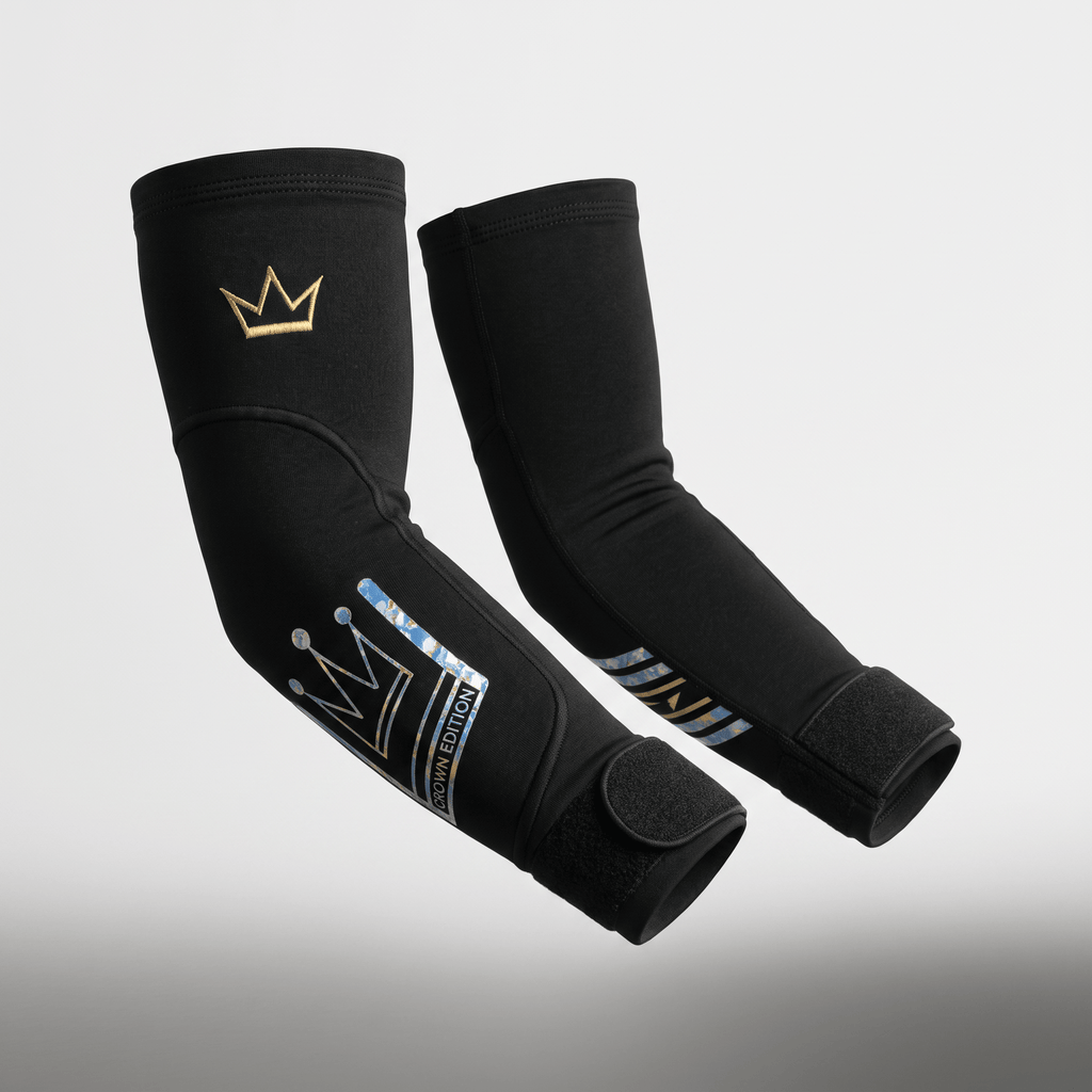 Pair of black elbow sleeves with gold crown logo and blue camouflage crown edition text.